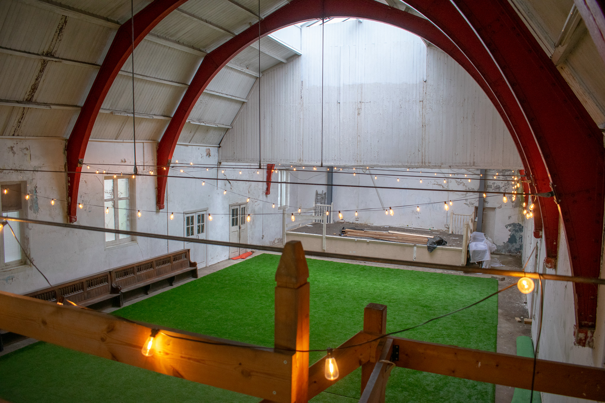 Spacious ARK Studios venue with red beams, ideal for workshops and receptions.