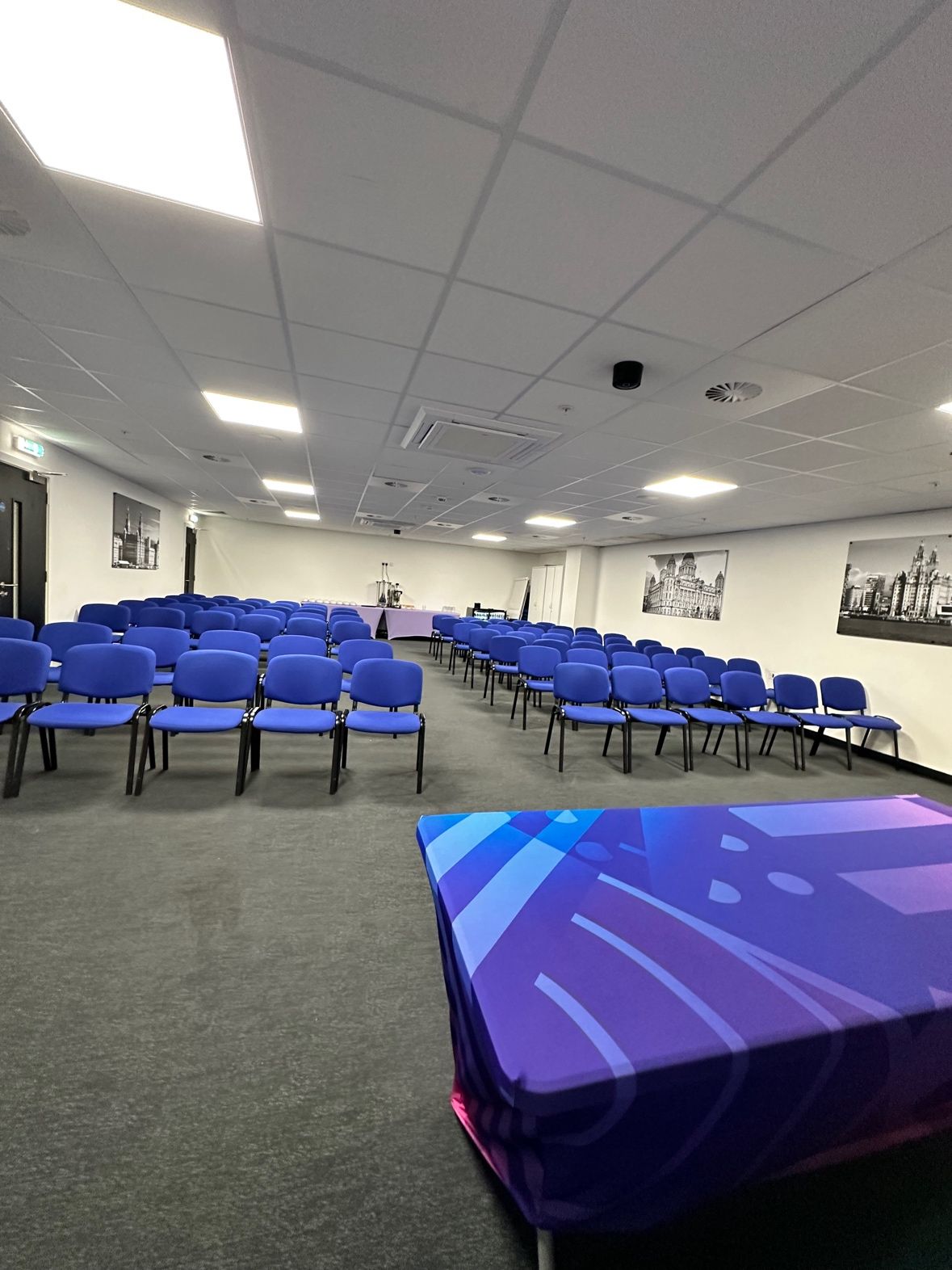 Meeting Room at Gravity Max with blue chairs, ideal for corporate events and training sessions.