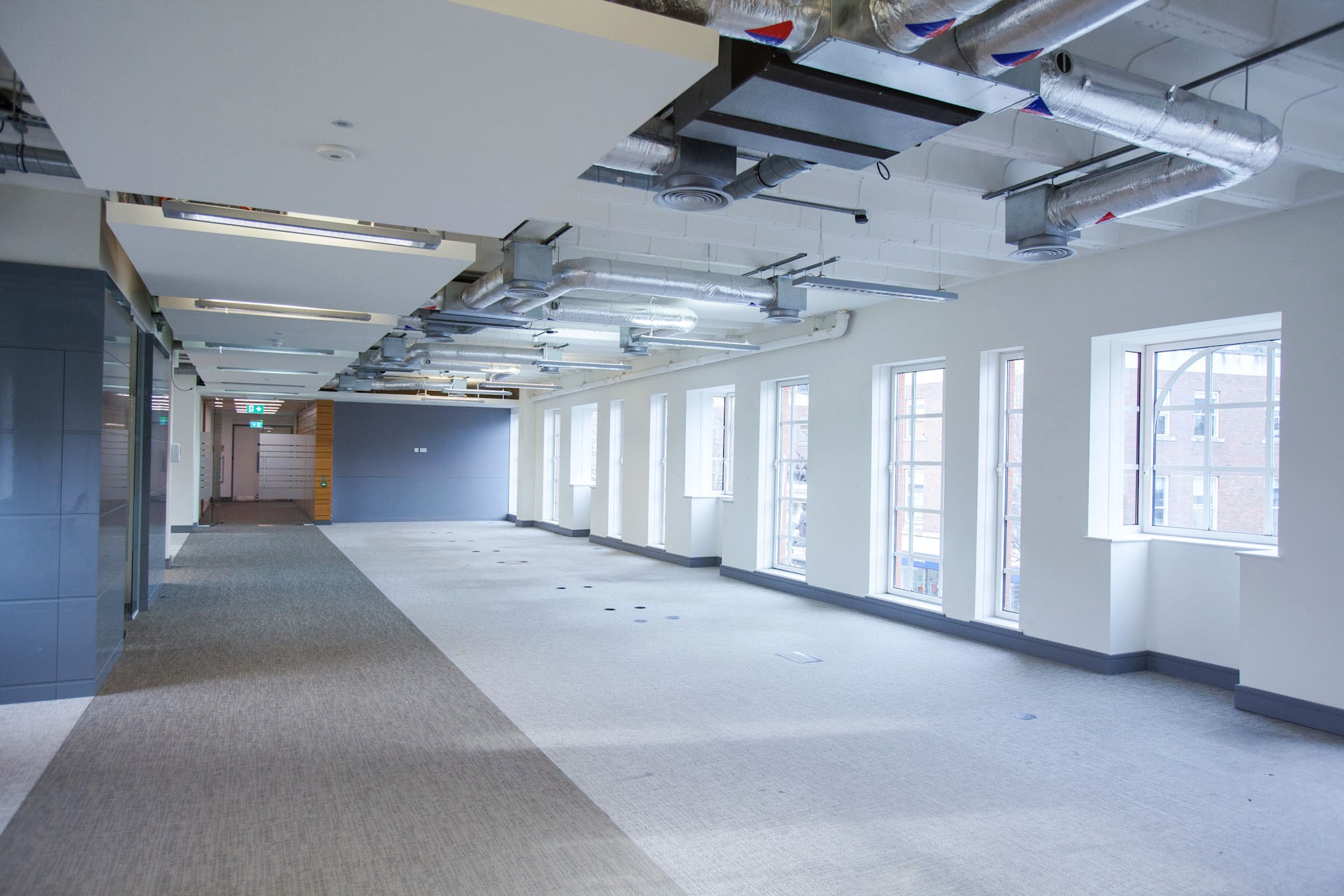 Spacious event space with large windows for corporate meetings and creative workshops.