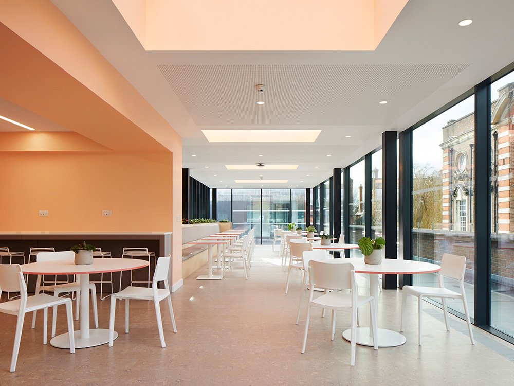 Modern event space at UCS Venues with round tables, ideal for workshops and conferences.