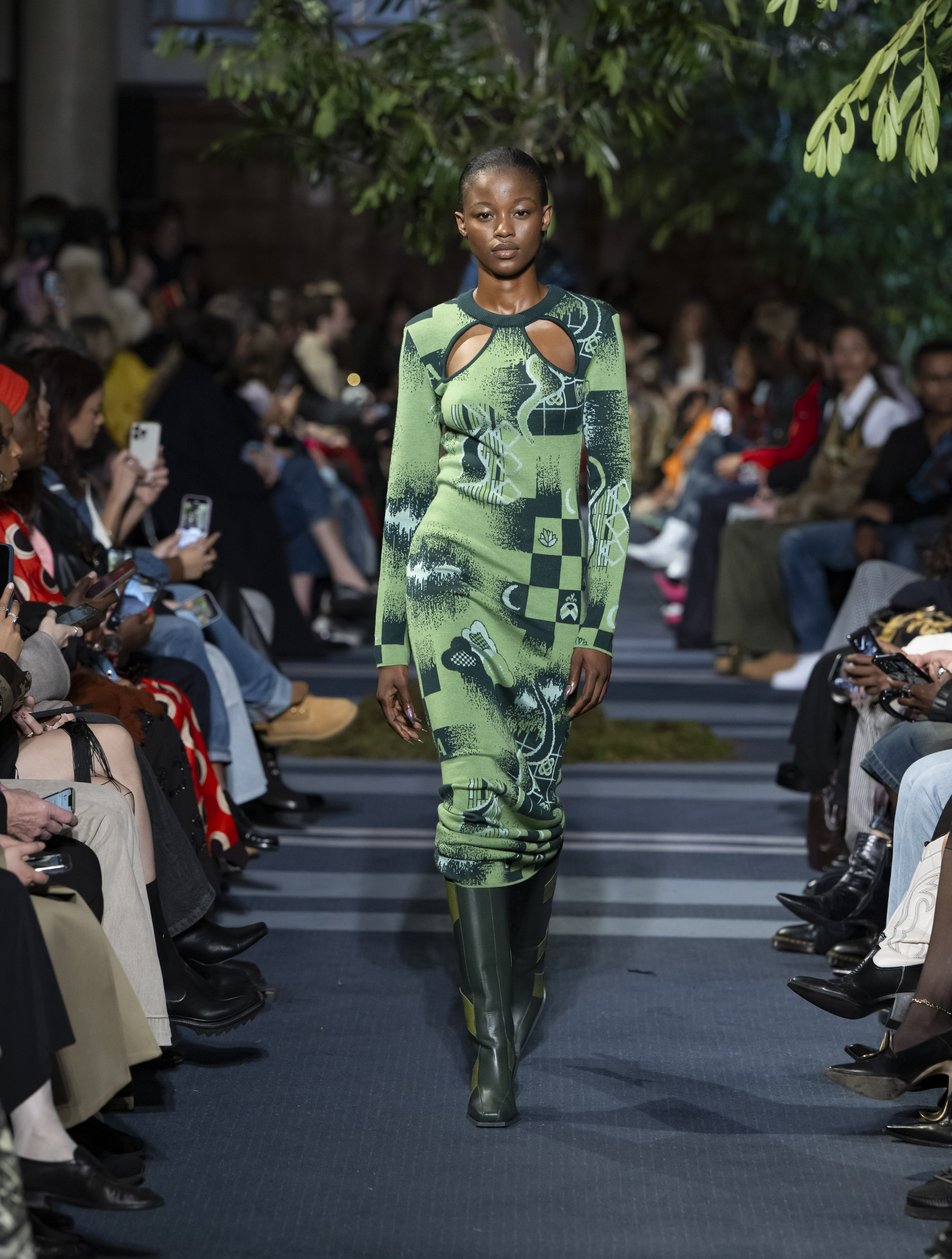 Fashion runway in lush Central Hall Westminster, showcasing innovative designs and audience engagement.