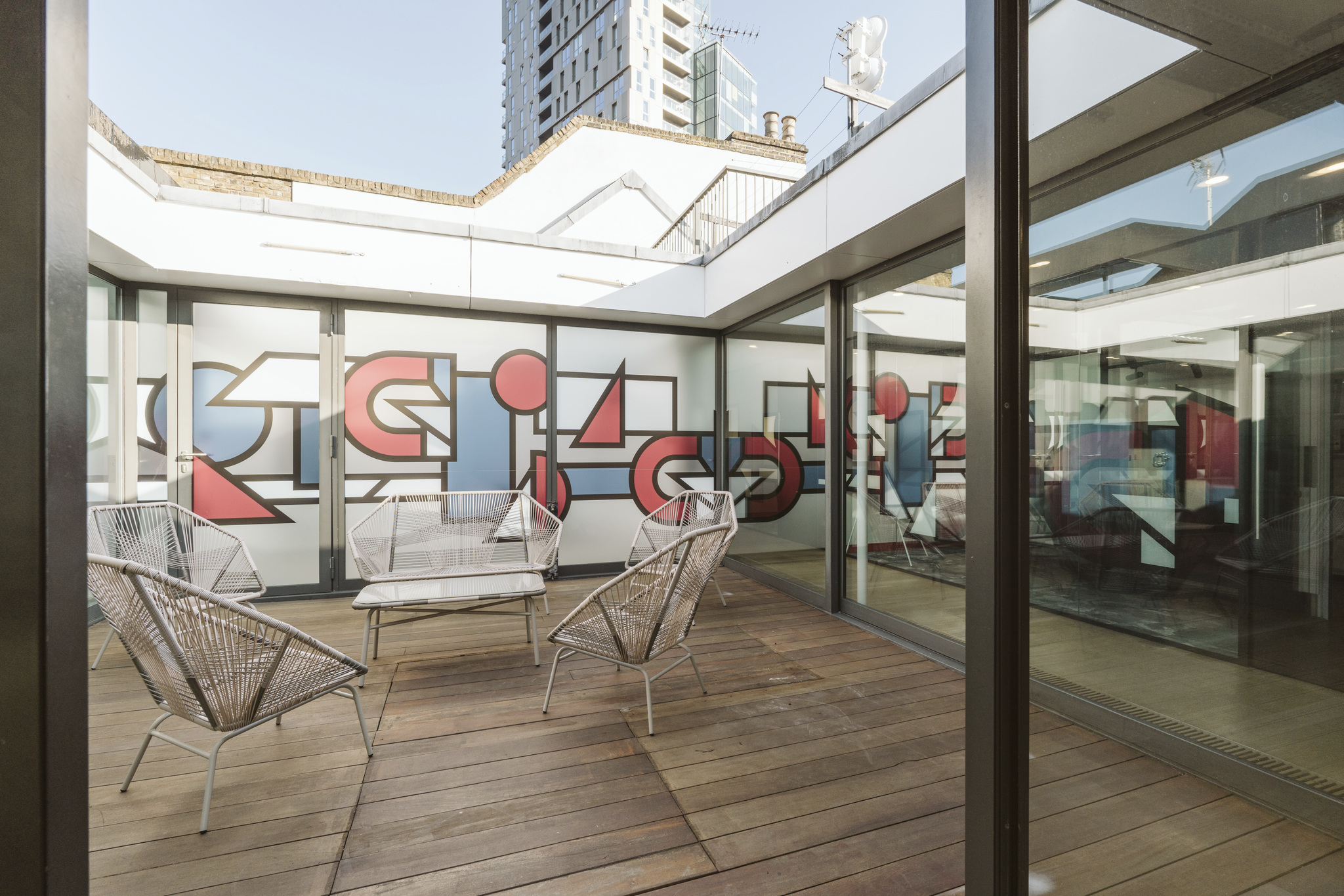 Modern meeting space with vibrant mural at Sky Guild Gaming Centre for creative events.