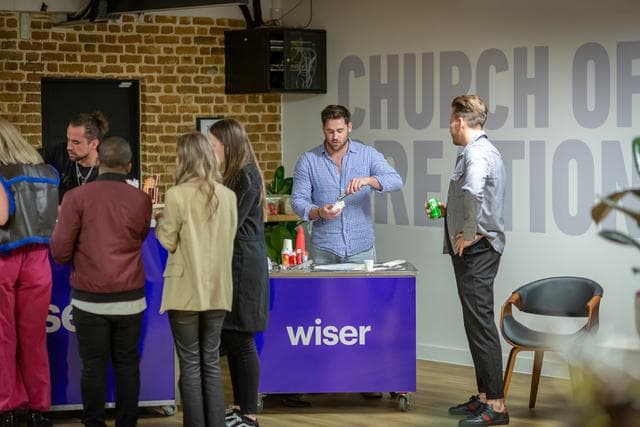 Vibrant networking event at EC1 Campus with attendees engaging over refreshments.