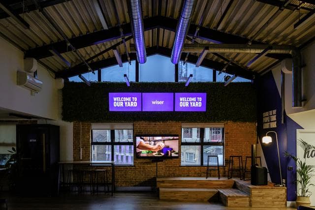 Modern EC1 Campus event space with vibrant signage, ideal for workshops and meetings.