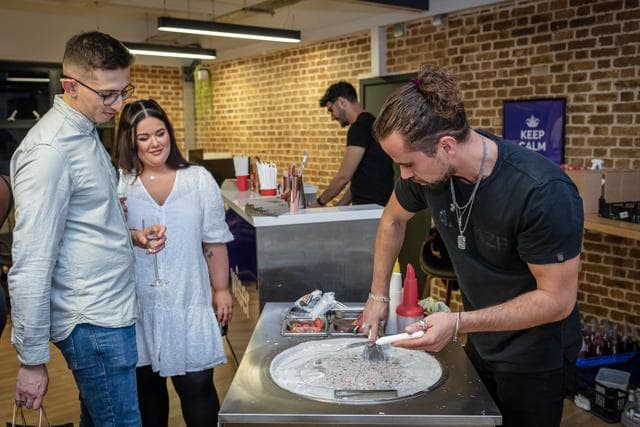 Interactive dessert event at EC1 Campus with rolled ice cream preparation.
