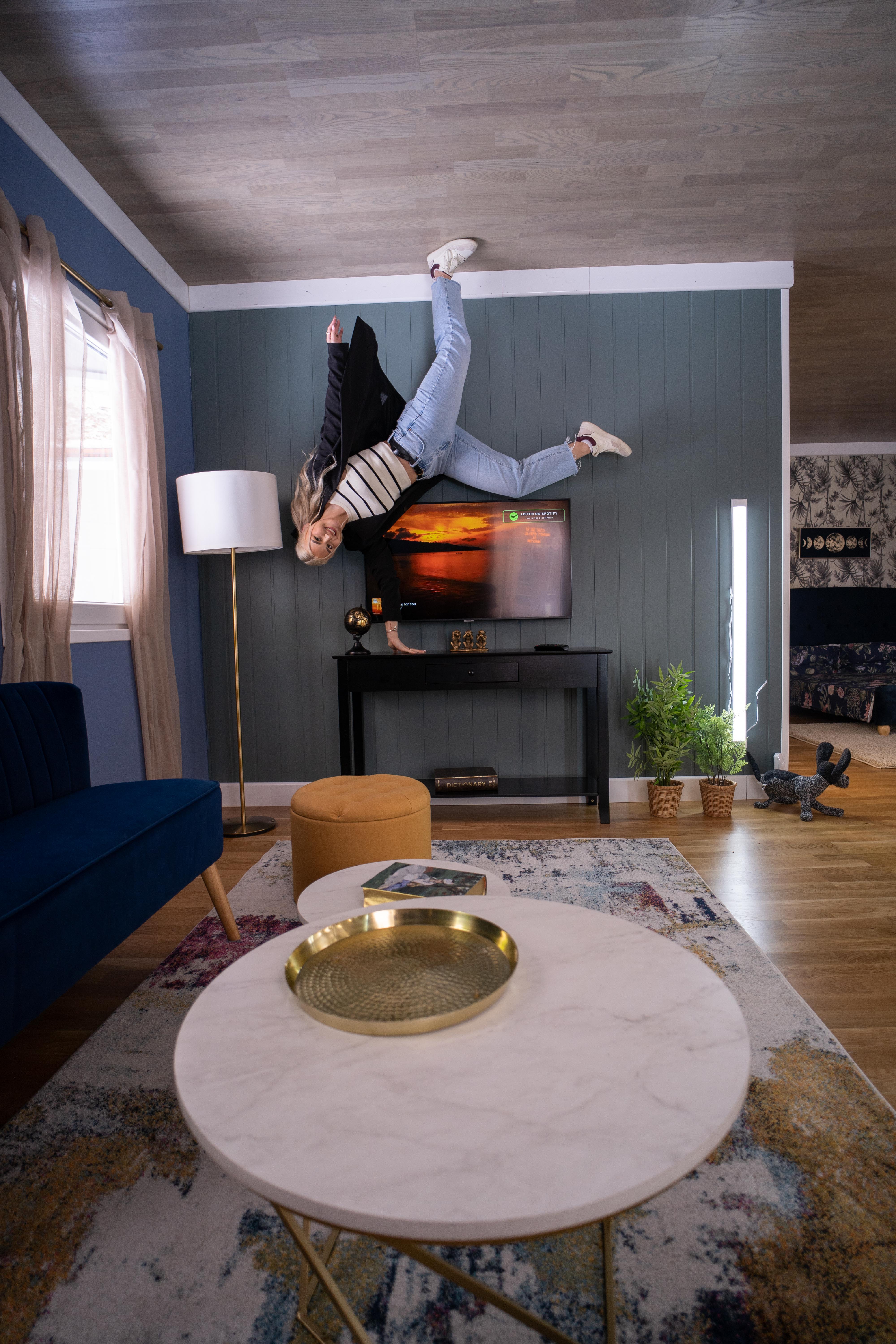 Upside Down House Westfield with a person defying gravity, perfect for unique events.