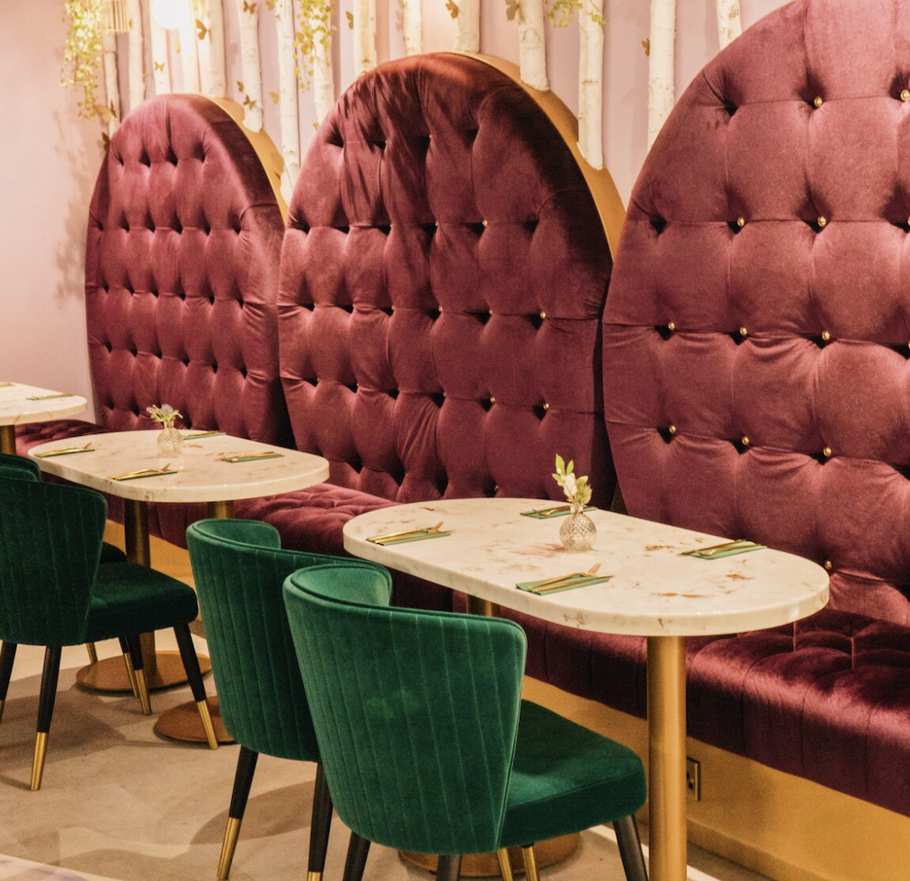 Stylish dining area with tufted purple seating, ideal for upscale events and gatherings.