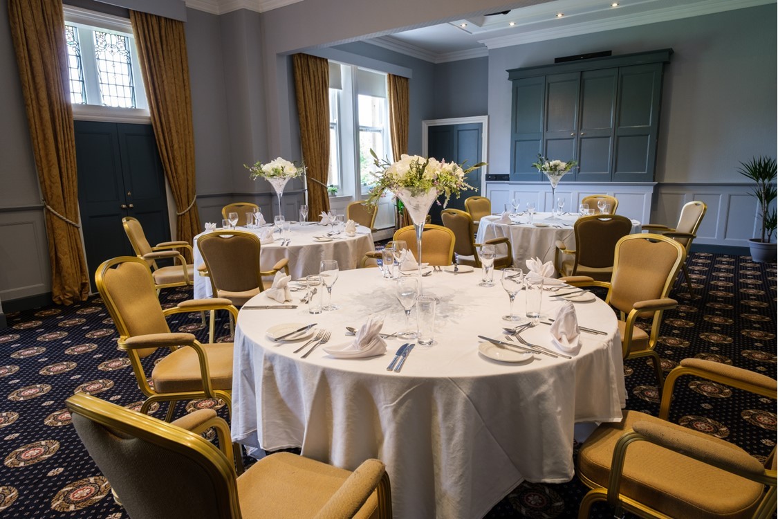 Elegant event space at Moor Hall Hotel with round tables, ideal for corporate gatherings.