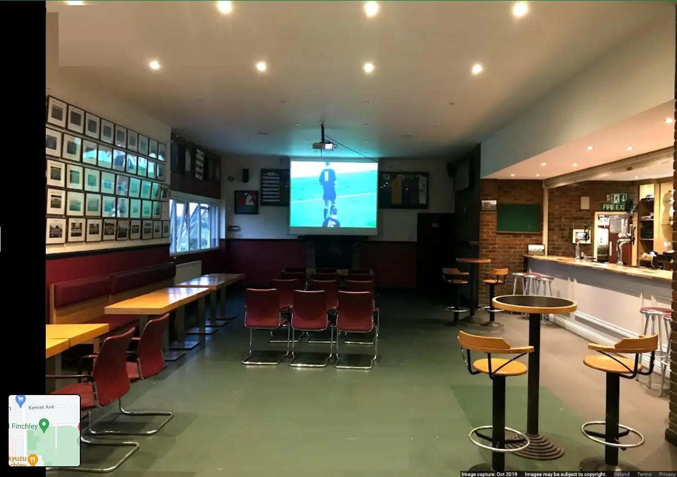 Versatile event space at Finchley RFC with large screen, ideal for gatherings and corporate events.