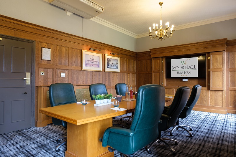 Aston meeting room at Moor Hall Hotel with wooden table and leather chairs for corporate events.