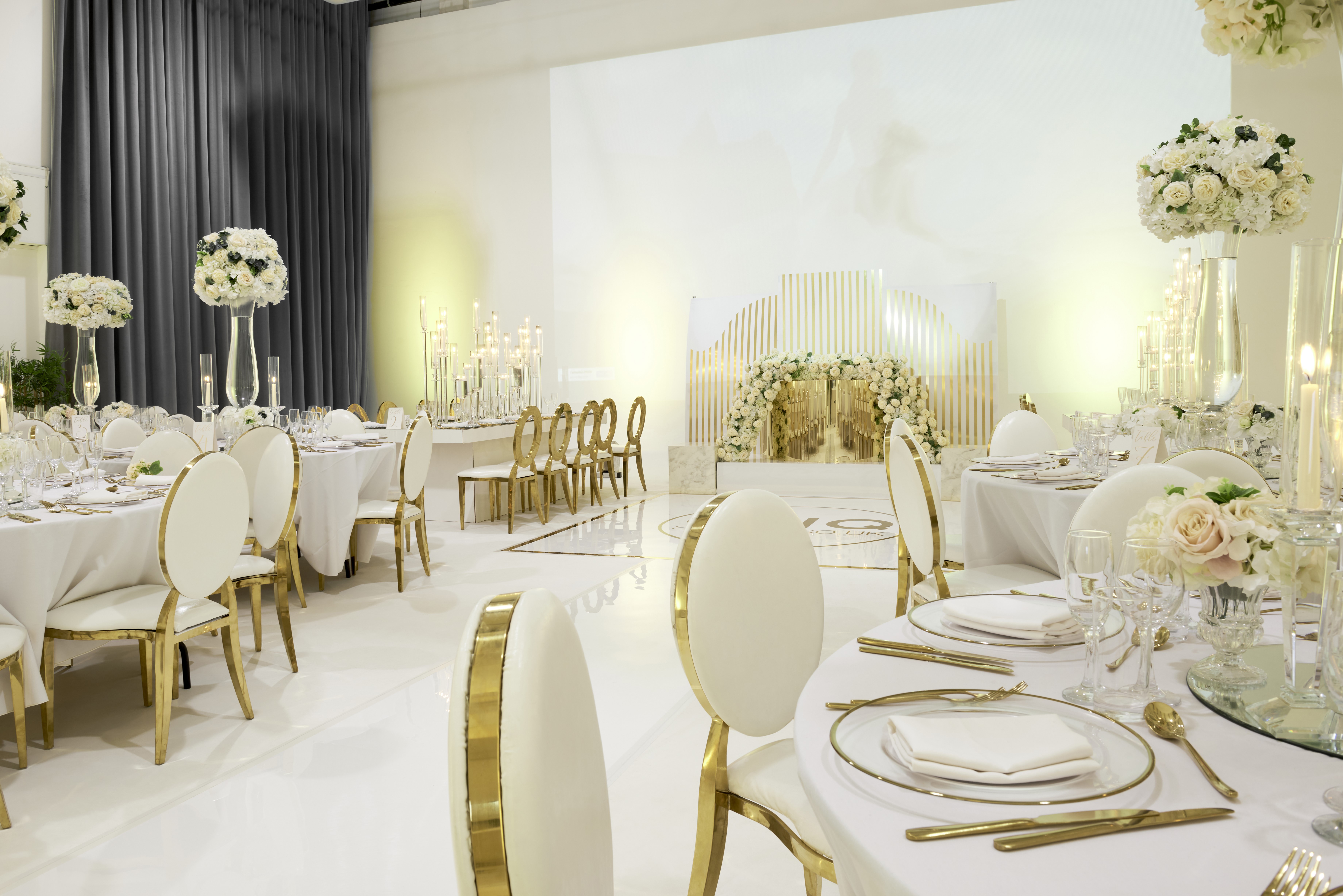 Elegant event space at S2 Royal Arsenal, featuring white and gold decor for weddings.