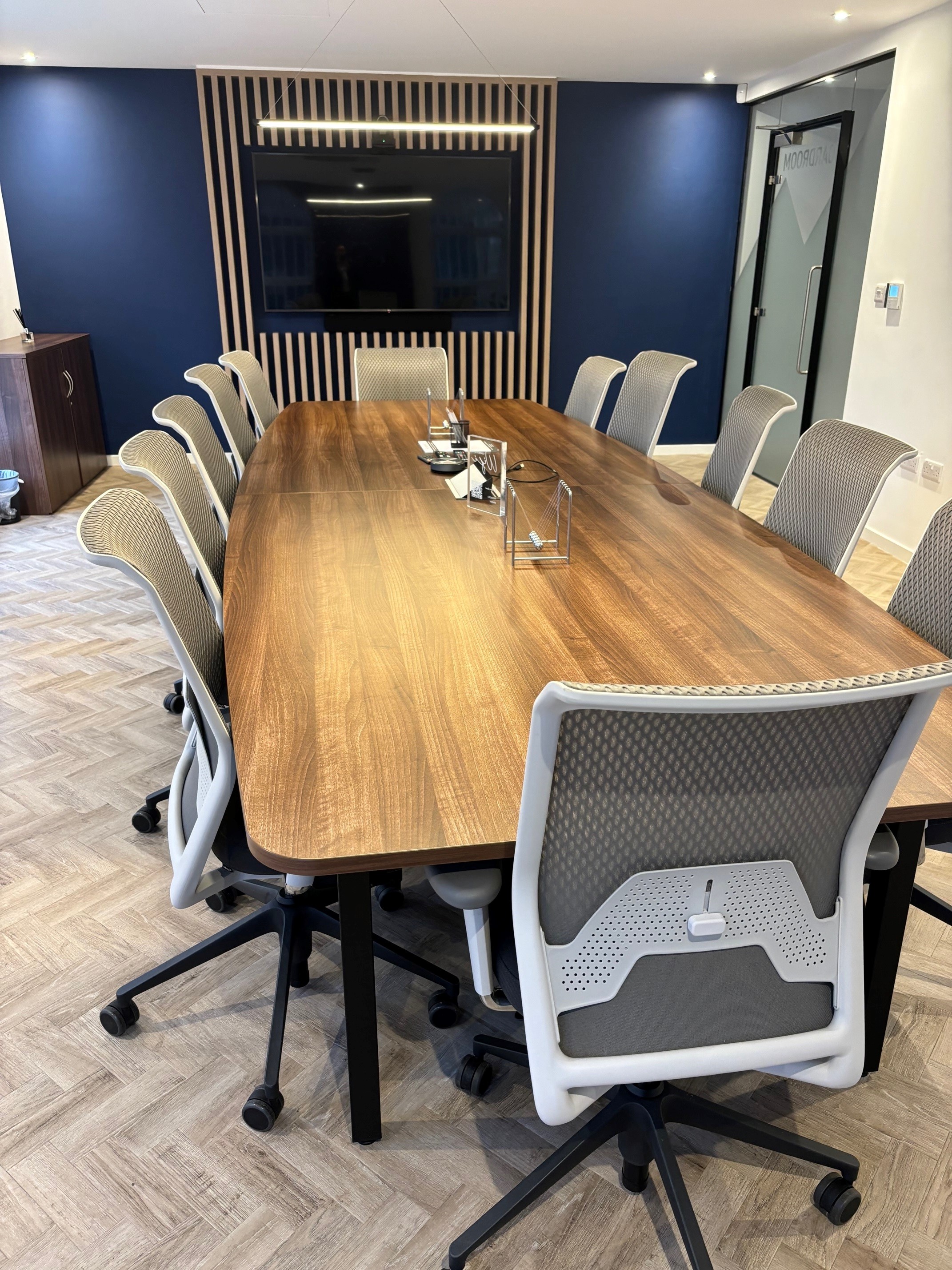 Modern conference room in St Peters House with large wooden table and ergonomic chairs.