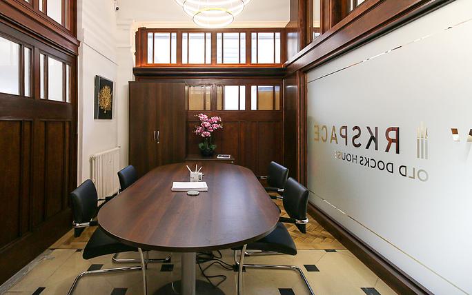 Meeting room in Old Docks House with wooden table, ideal for corporate meetings and workshops.