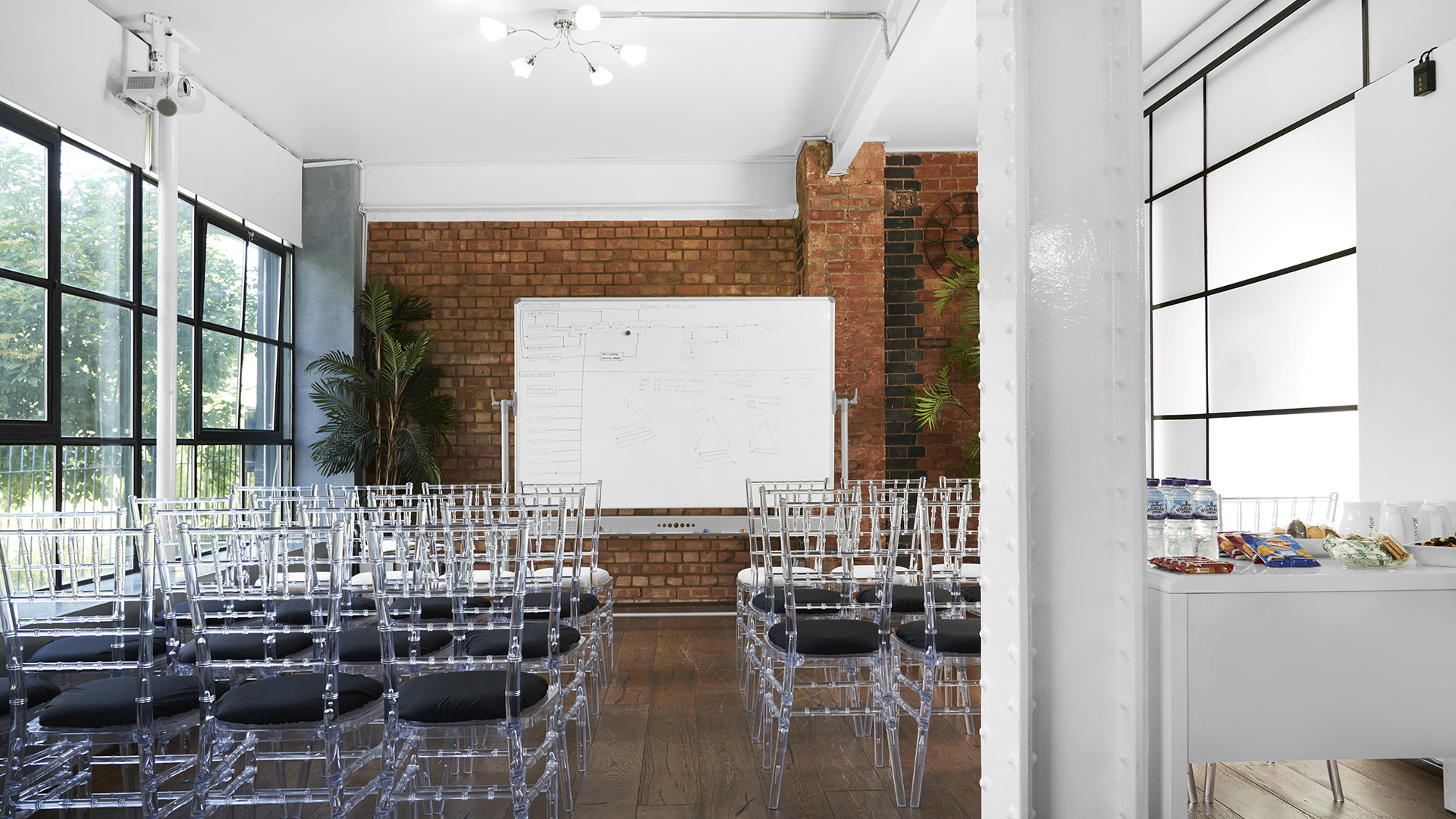 Modern meeting space with acrylic chairs for S1 Apartment events and brainstorming sessions.