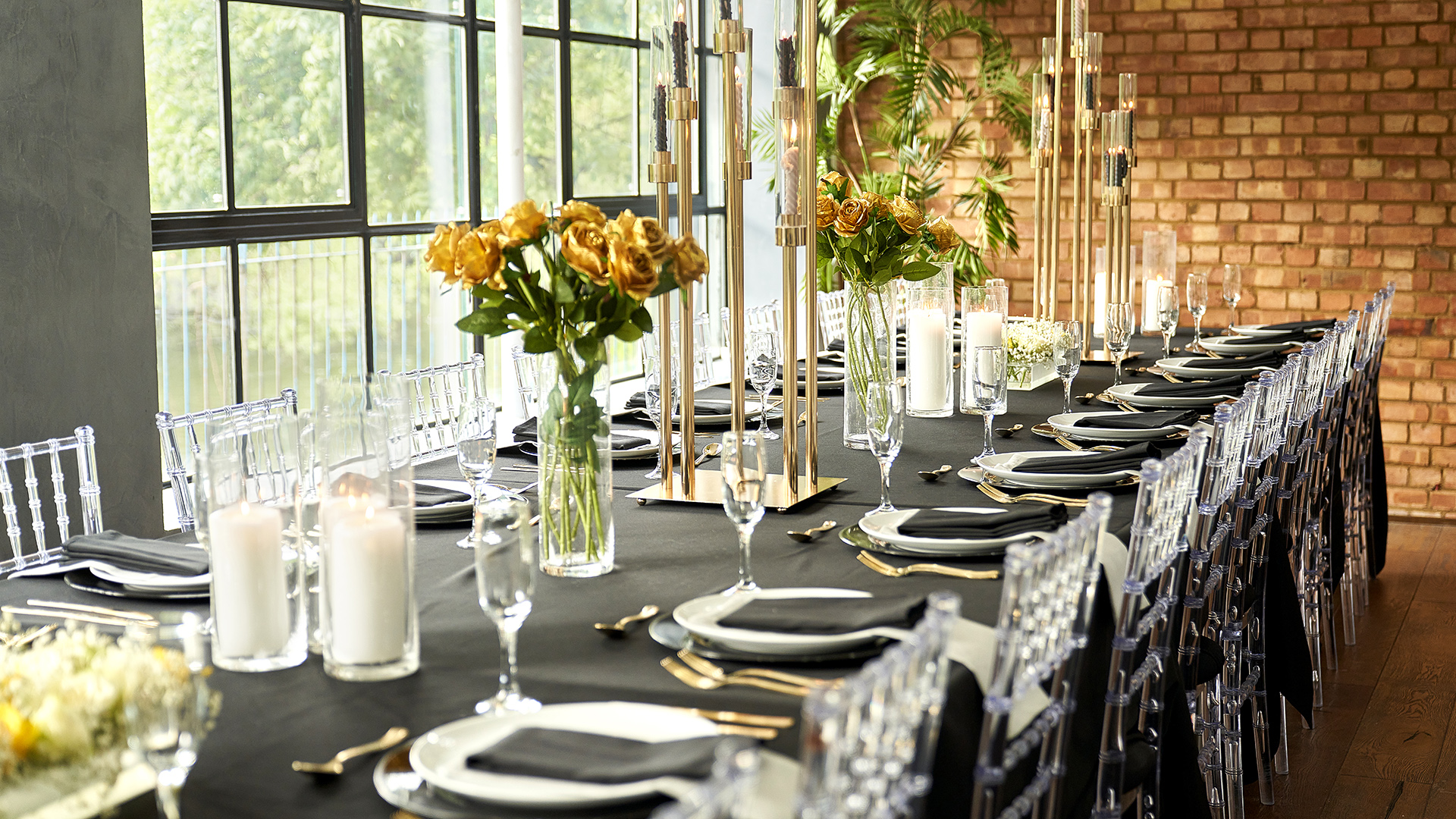 Elegant dining setup with black tablecloth for S1 Apartment events and gatherings.