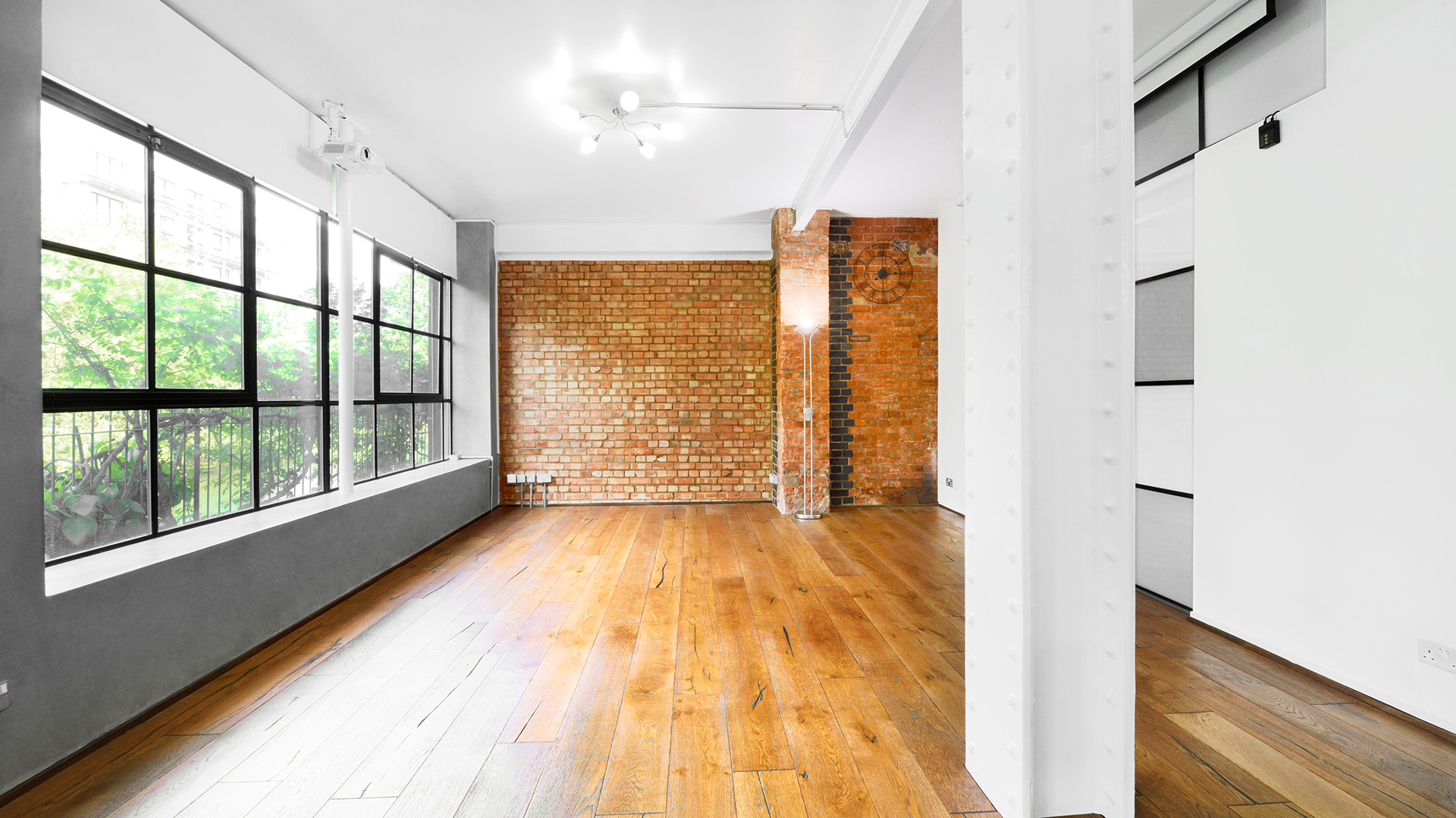 Versatile S1 Apartment event space with large windows for meetings and gatherings.