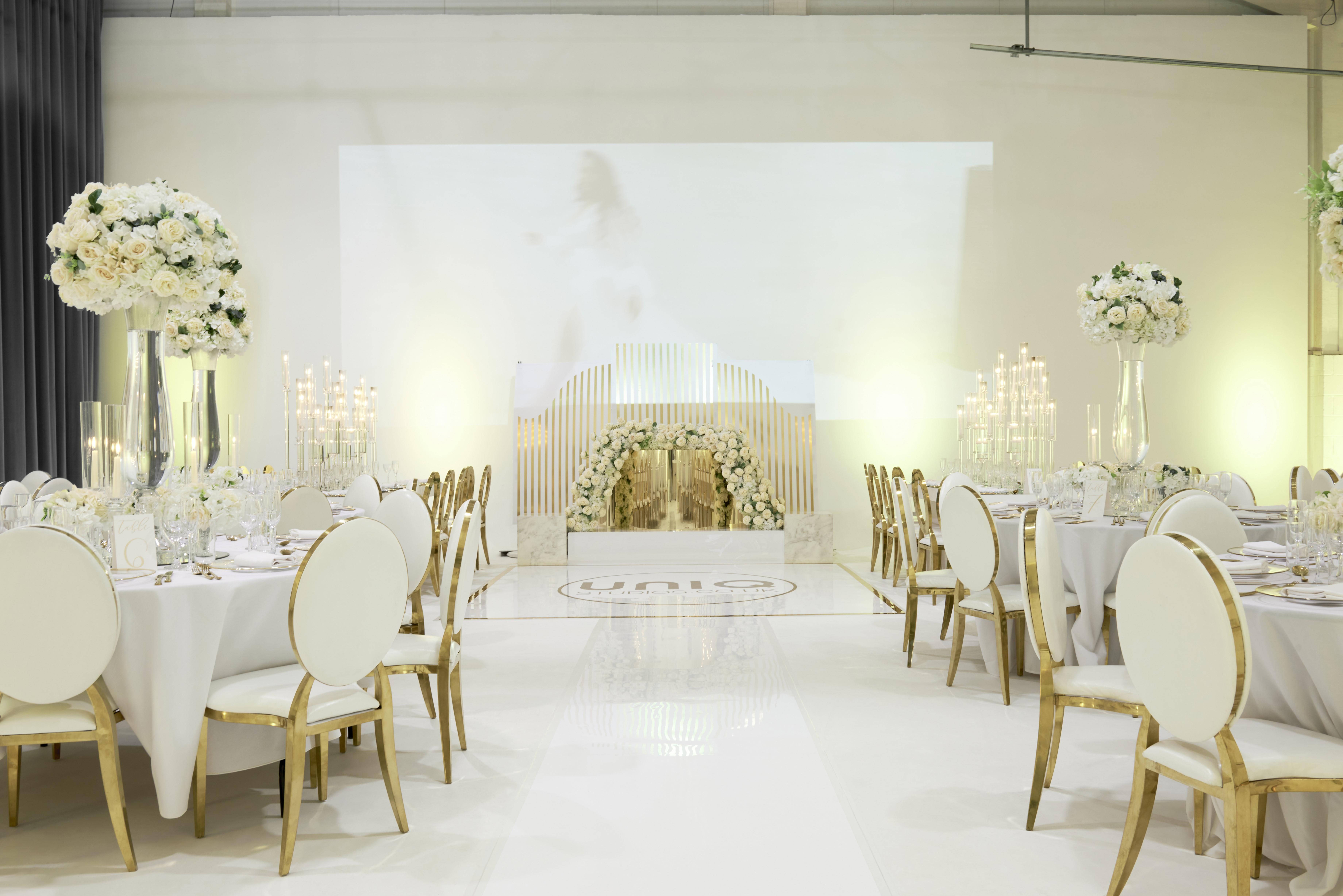 Elegant event space at S2 Royal Arsenal, perfect for weddings and galas with floral decor.
