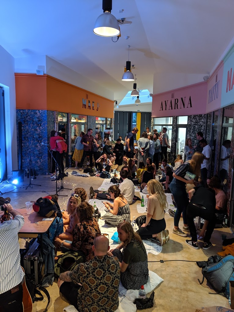 Vibrant gathering at The Atrium, Peckham Palms; casual networking event with live entertainment.