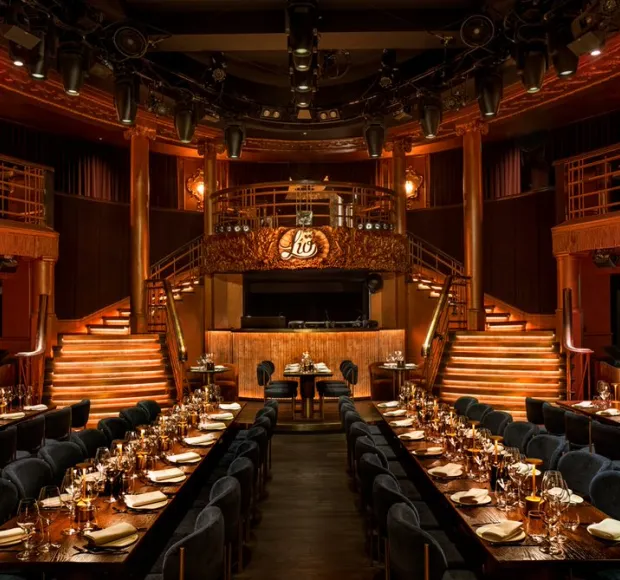 Elegant event space in Lio London with tiered seating for upscale dinners and gatherings.