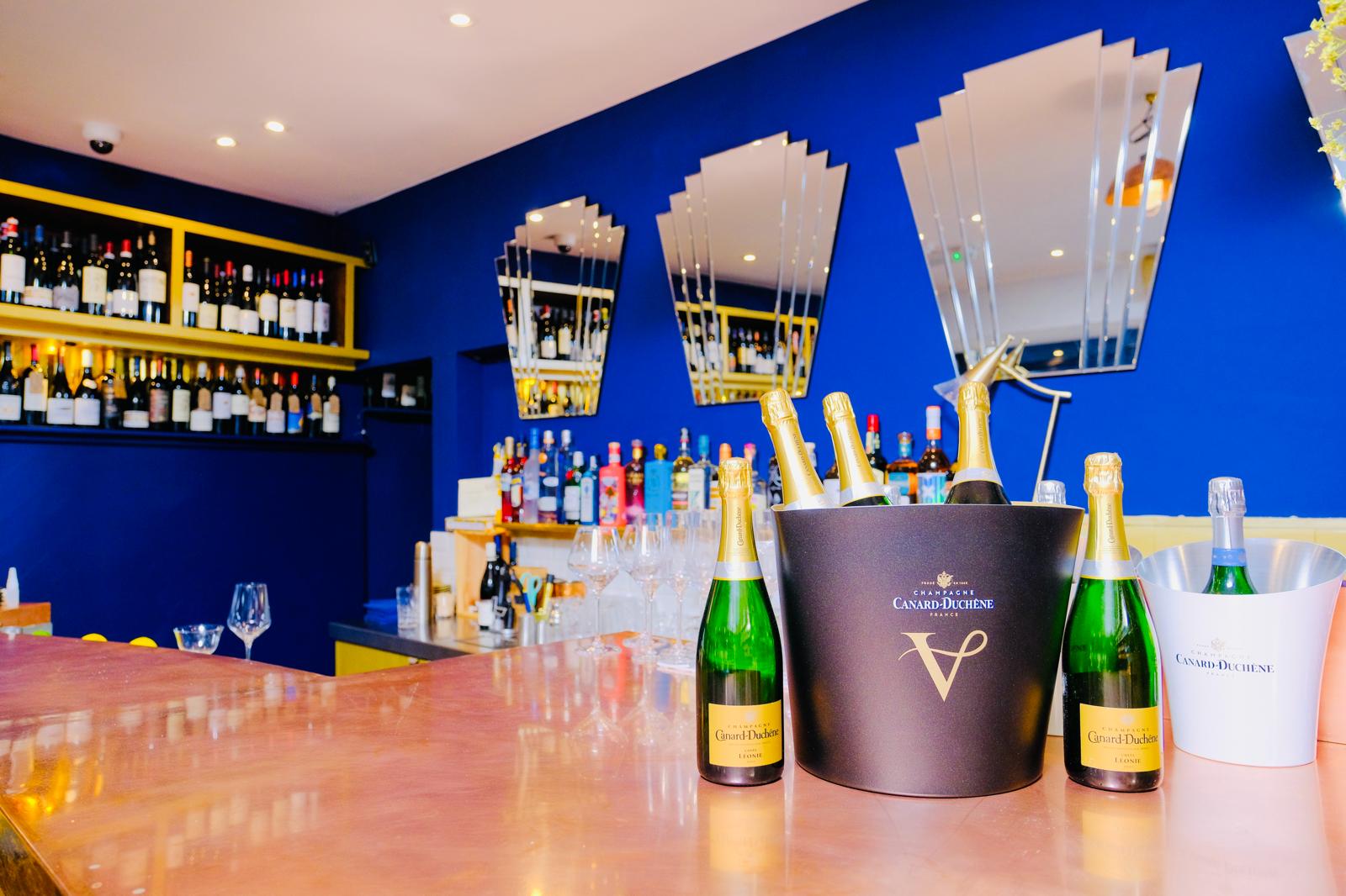 Stylish bar setup with premium spirits at Voila! Wine Bar for upscale events.