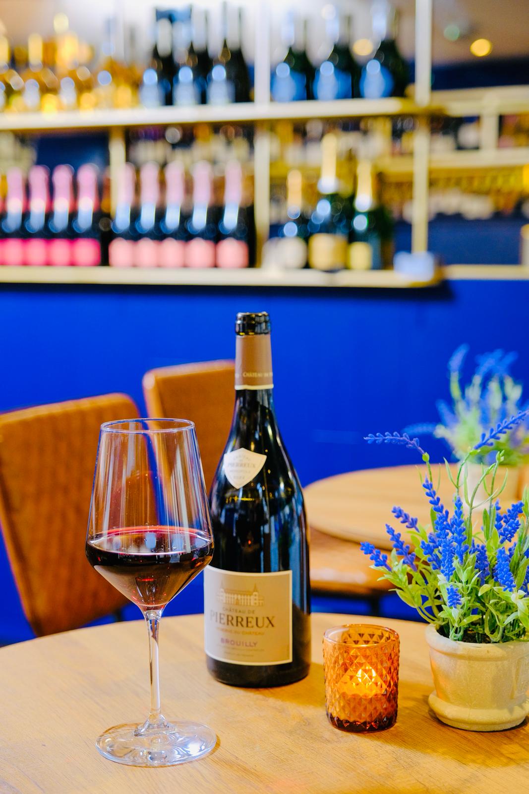 Elegant venue at Voila! Wine Bar for networking events with wine and floral decor.