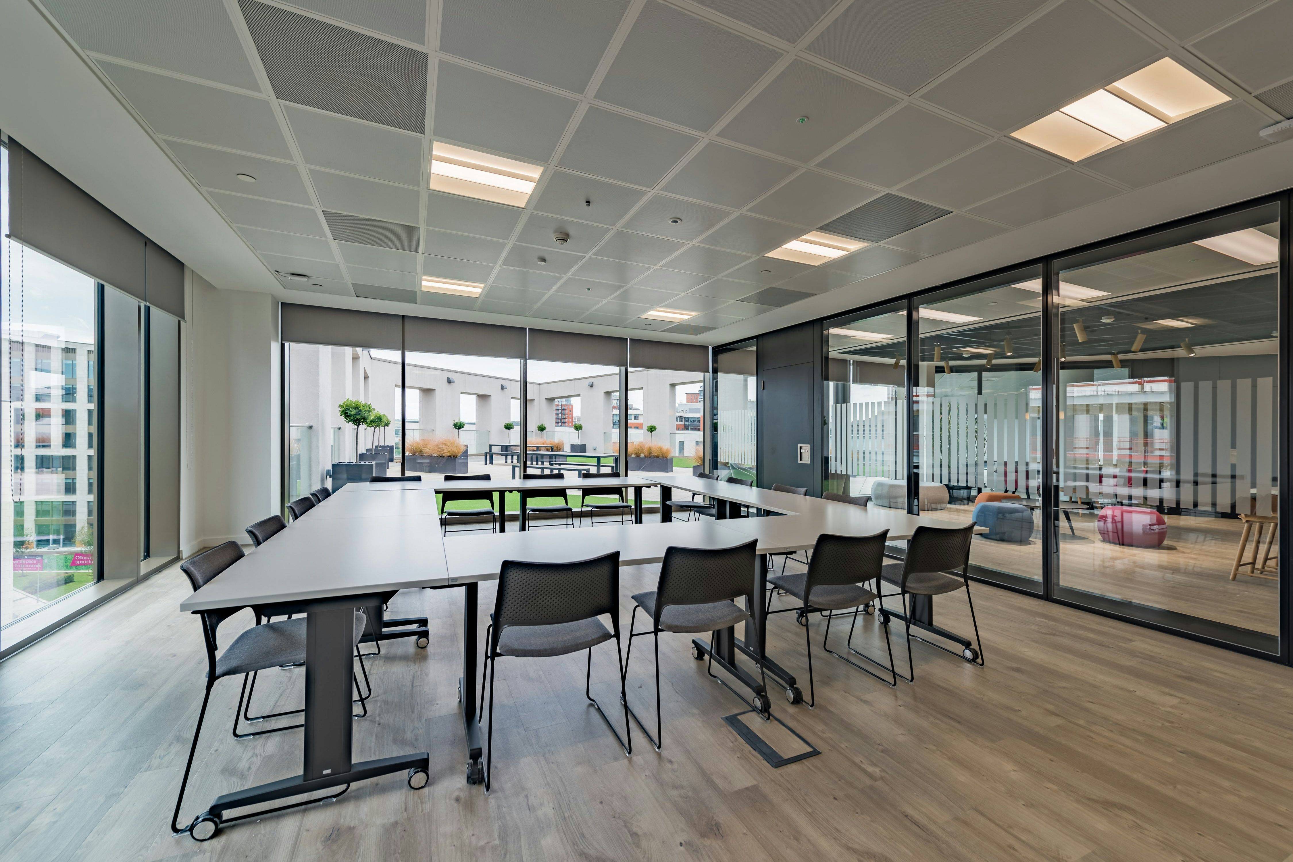 Modern meeting room with large table, ergonomic chairs, ideal for collaborative events.