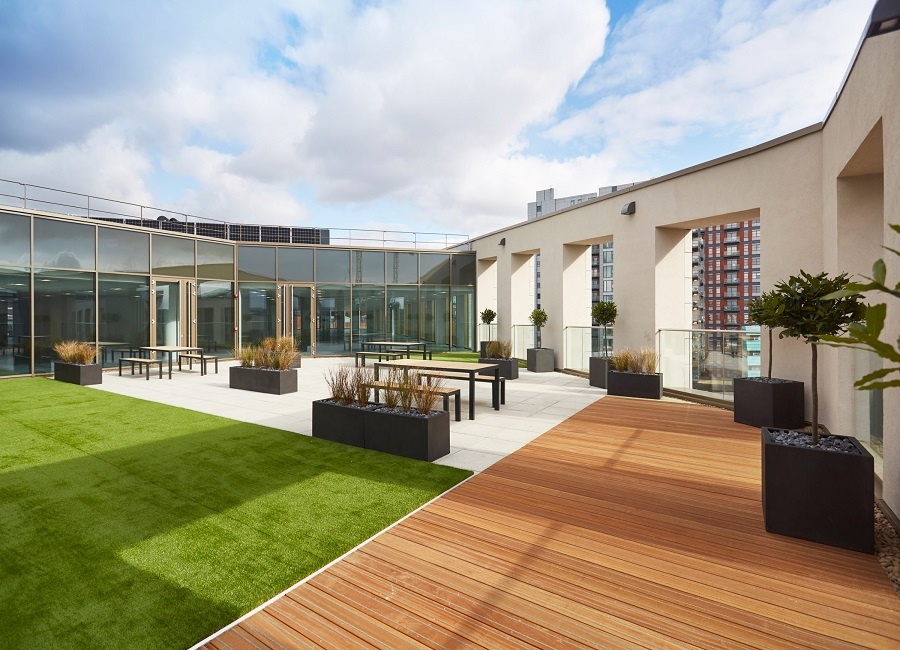 Versatile outdoor event space with greenery and modern design for receptions and networking.