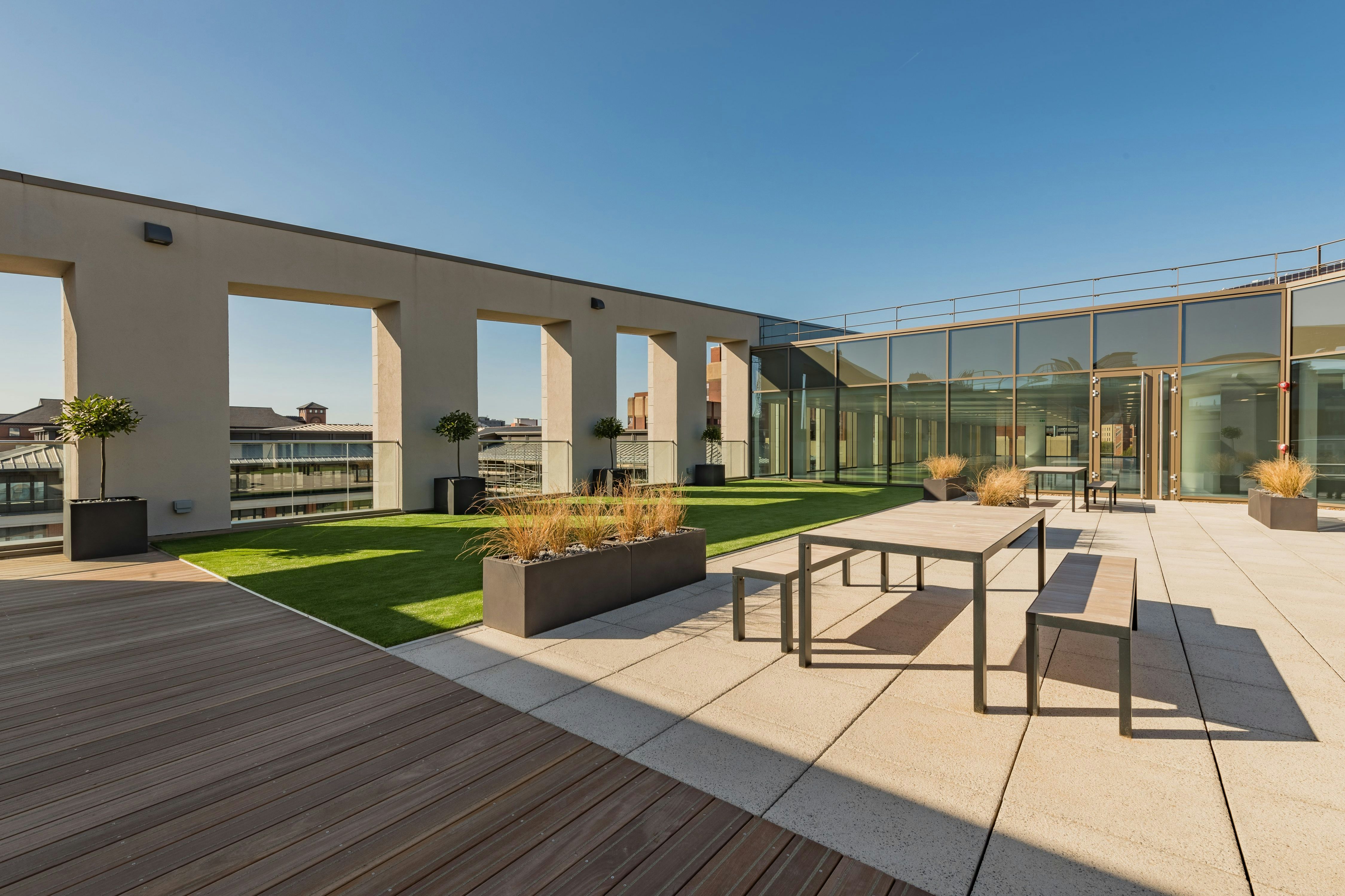 Modern rooftop terrace with sleek furniture, perfect for outdoor events and receptions.