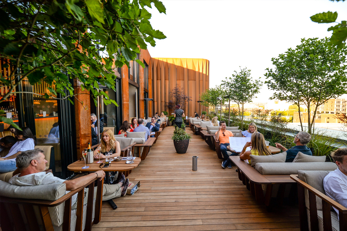 Vibrant outdoor venue with wooden deck for networking events and gatherings.