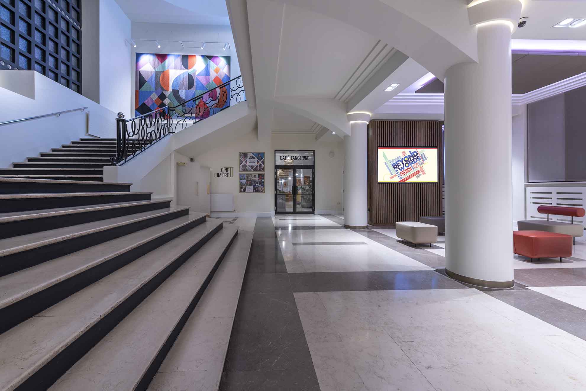 Modern lobby at Institut français du Royaume-Uni with elegant staircase for events.