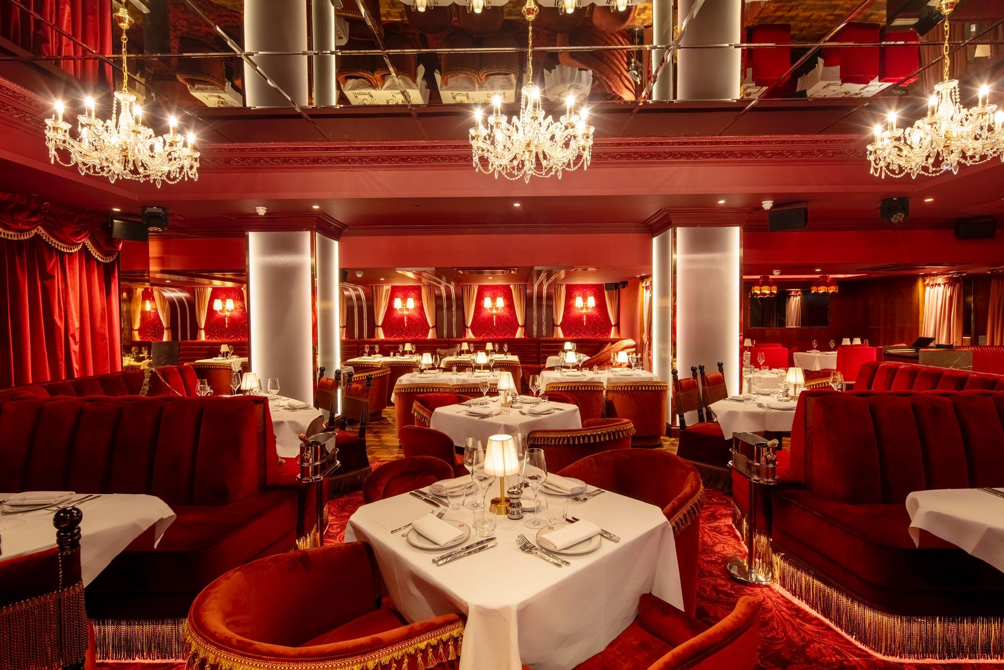 Elegant dining venue with rich red decor, perfect for upscale events and intimate gatherings.