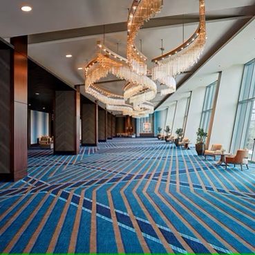 Spacious Houston Ballroom with elegant chandeliers, perfect for conferences and events.