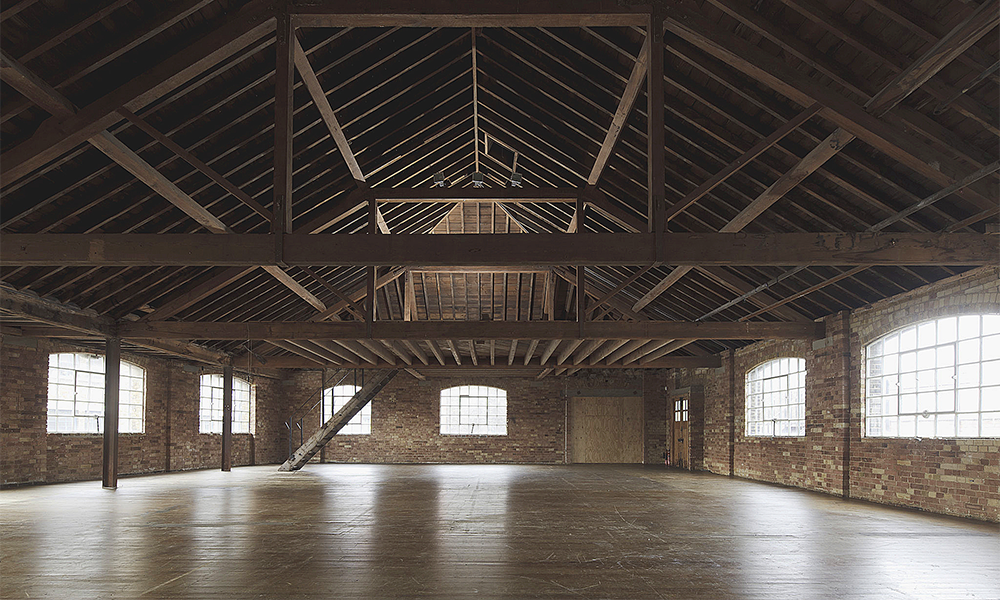 Industrial event venue with exposed brick and timber for corporate events and workshops.