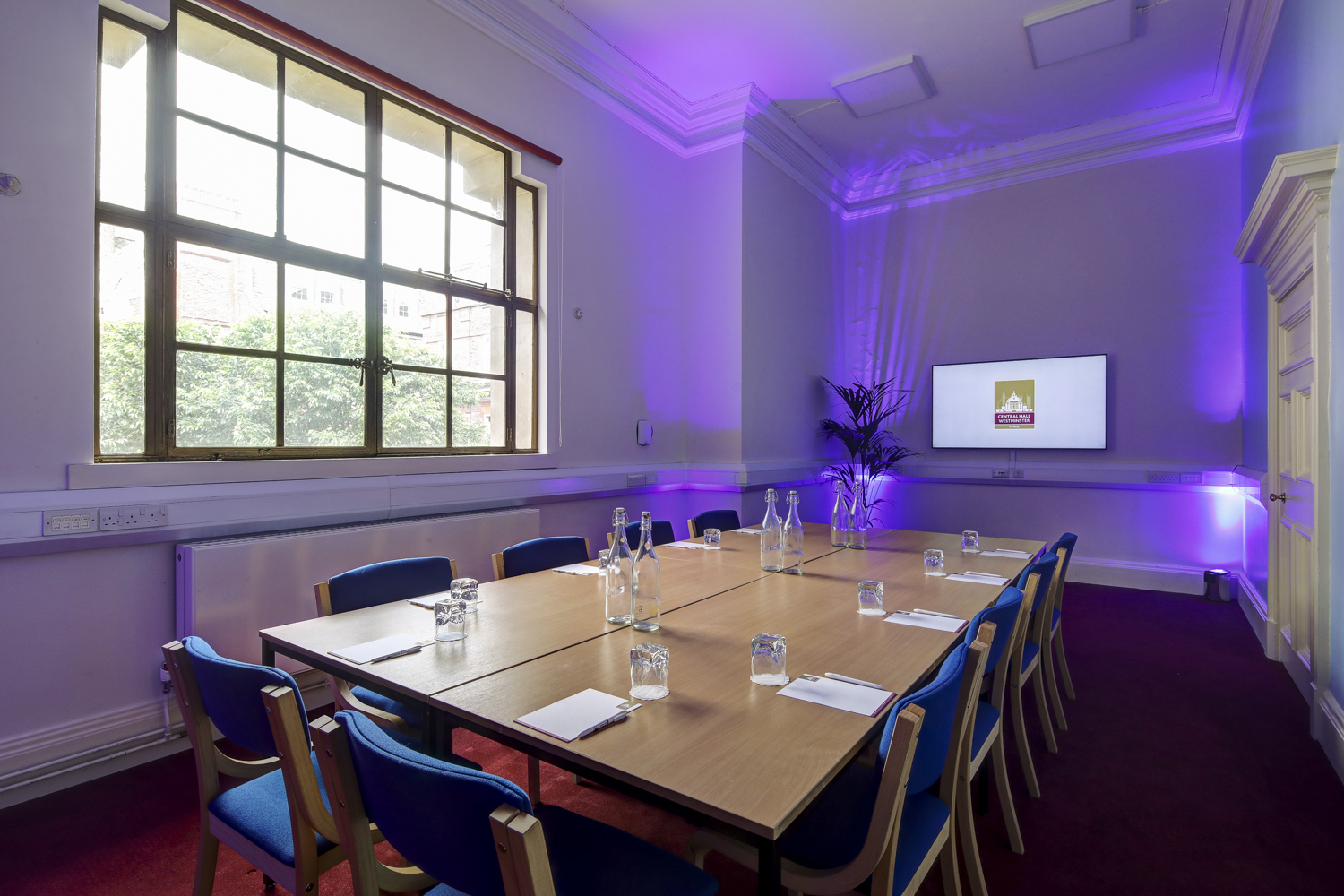 Syndicate Rooms in Central Hall Westminster, modern meeting space with purple lighting.