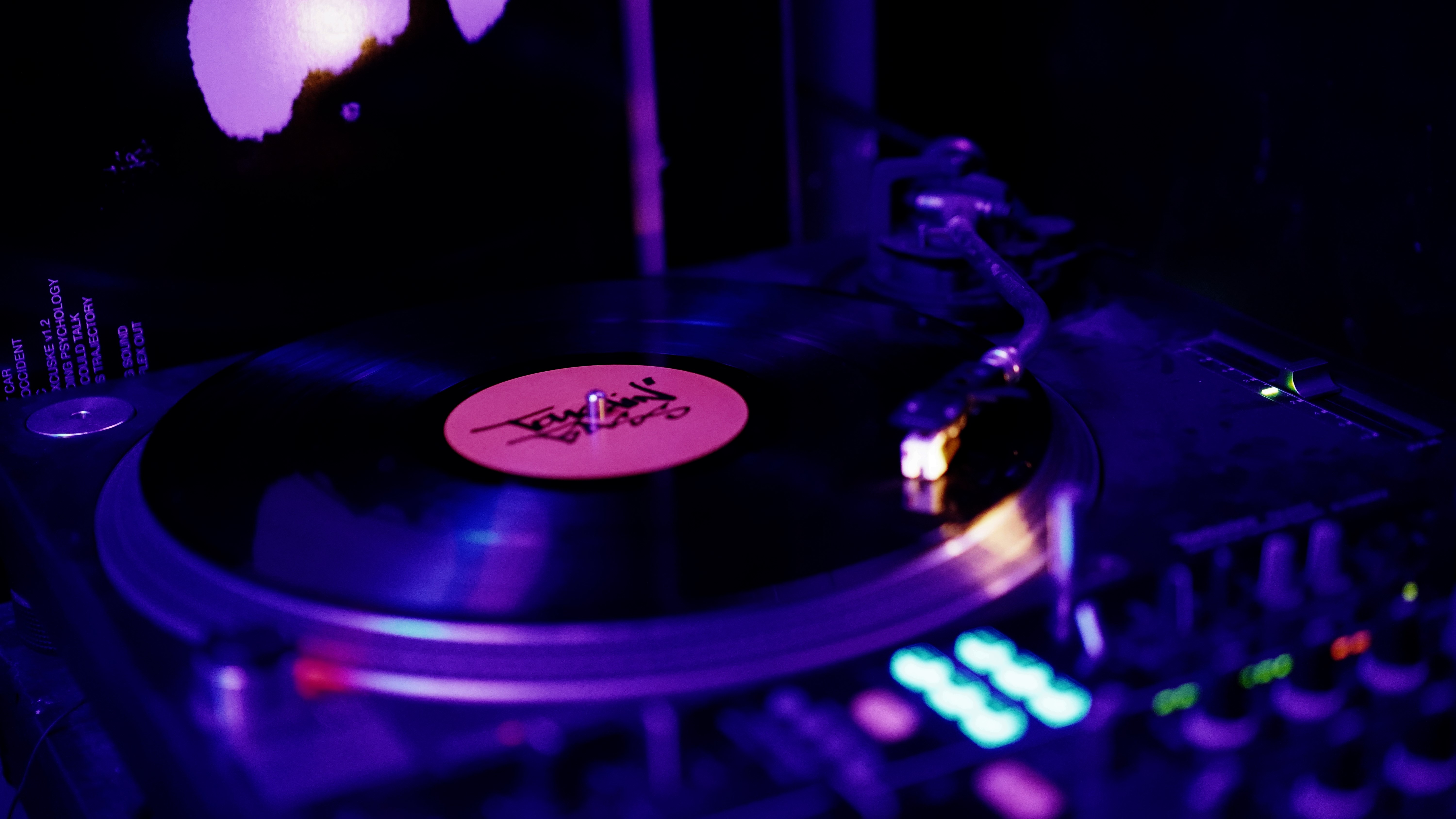 Close-up of a vibrant turntable at a lively music event for networking and entertainment.