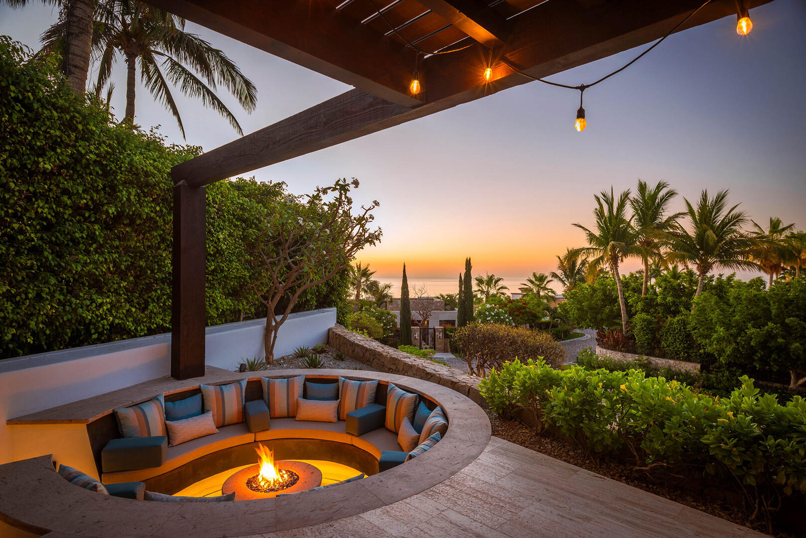 Casa De Salinas executive retreat breakout space with sunset view and bistro lighting.