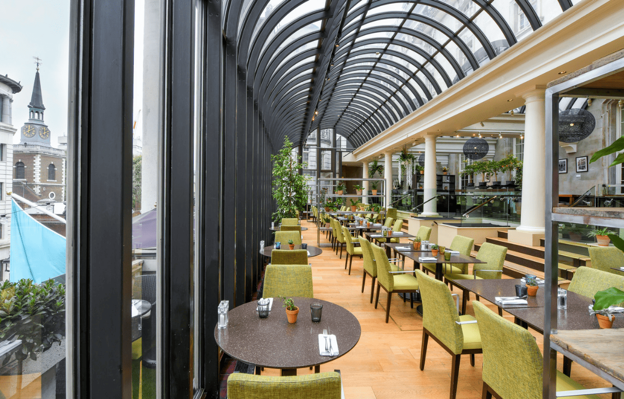 Stylish restaurant with large windows, perfect for networking events and intimate gatherings.