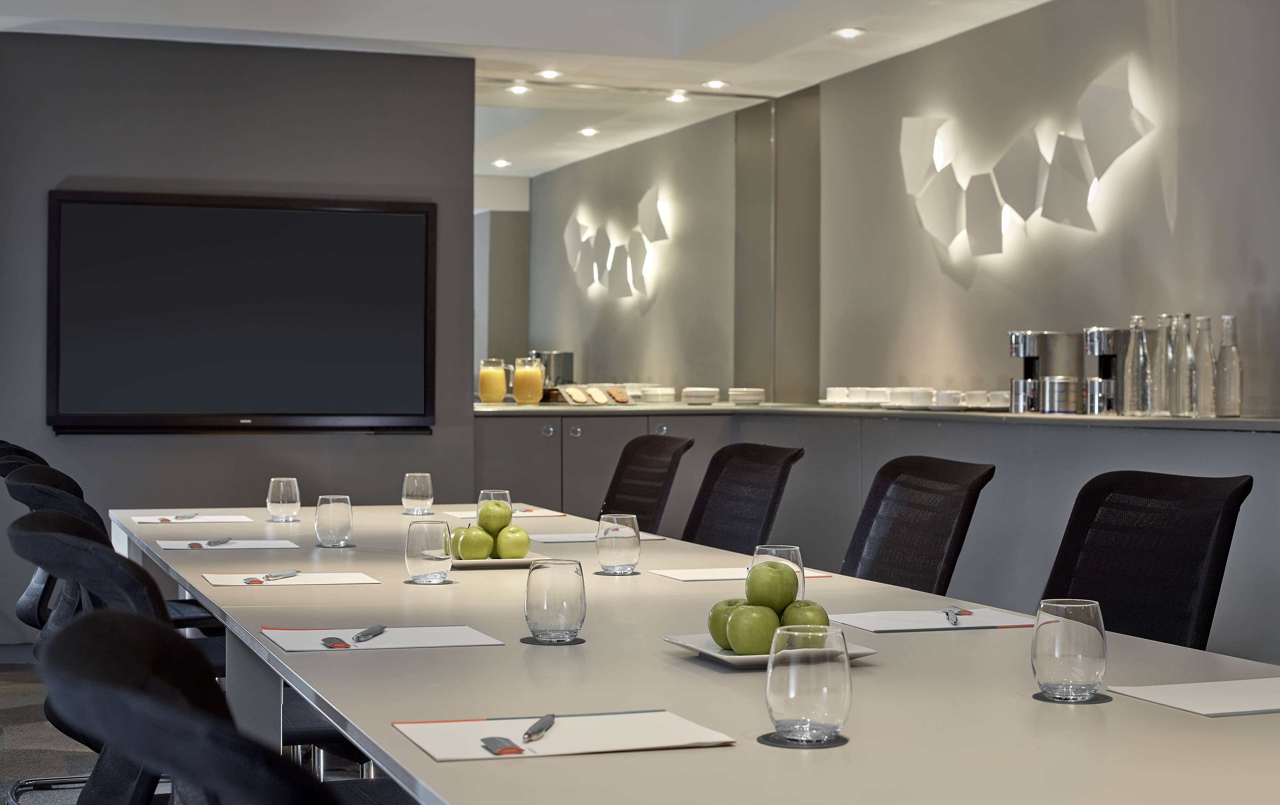 Modern Mayfair Suite meeting room with sleek table, ideal for corporate events.