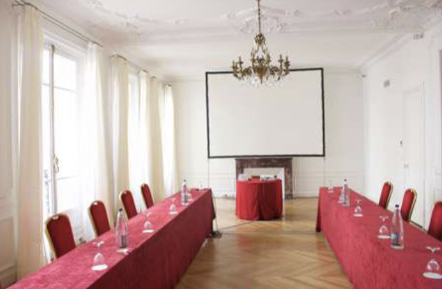 Elegant meeting room with red tablecloths for corporate events and workshops.