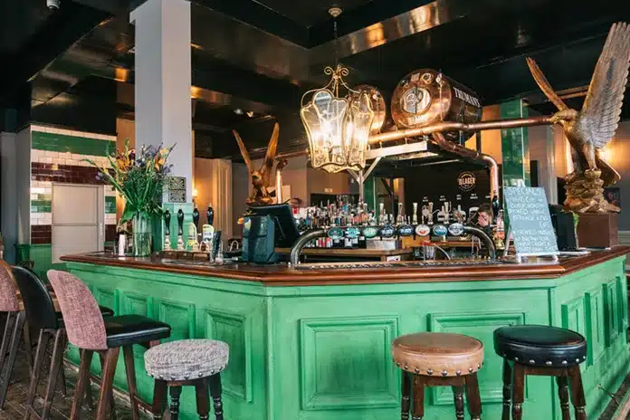 Vibrant Azzurra Bar terrace with a green counter for casual networking events.