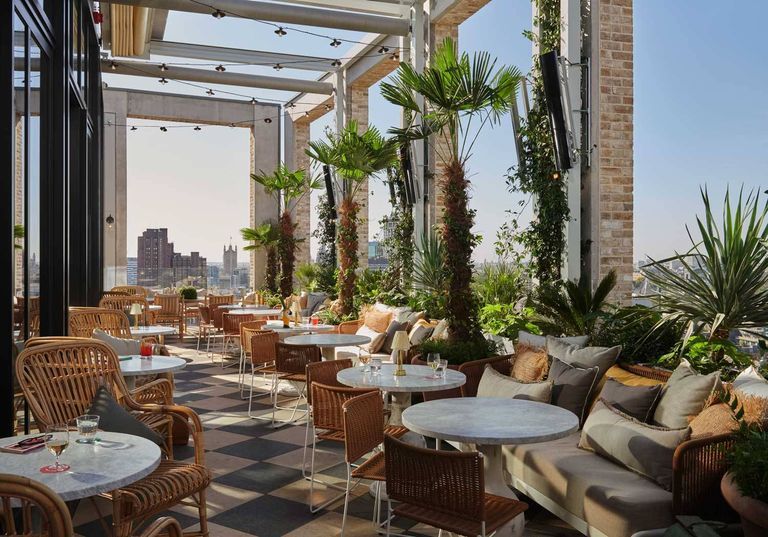 Stylish rooftop venue at Azzurra Bar with lush greenery, ideal for upscale events.