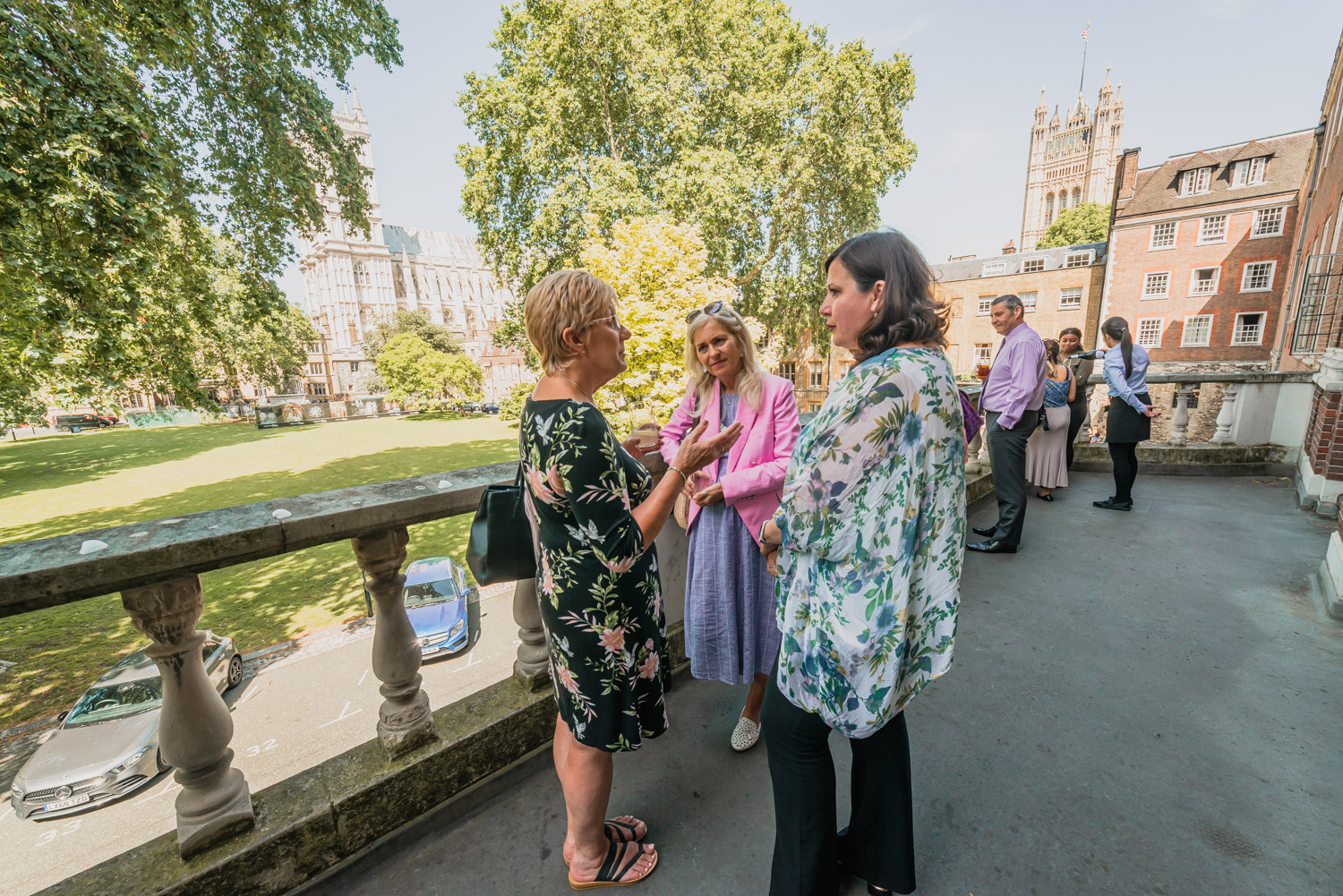 Outdoor summer party networking at Church House, featuring lush greenery and historic backdrop.