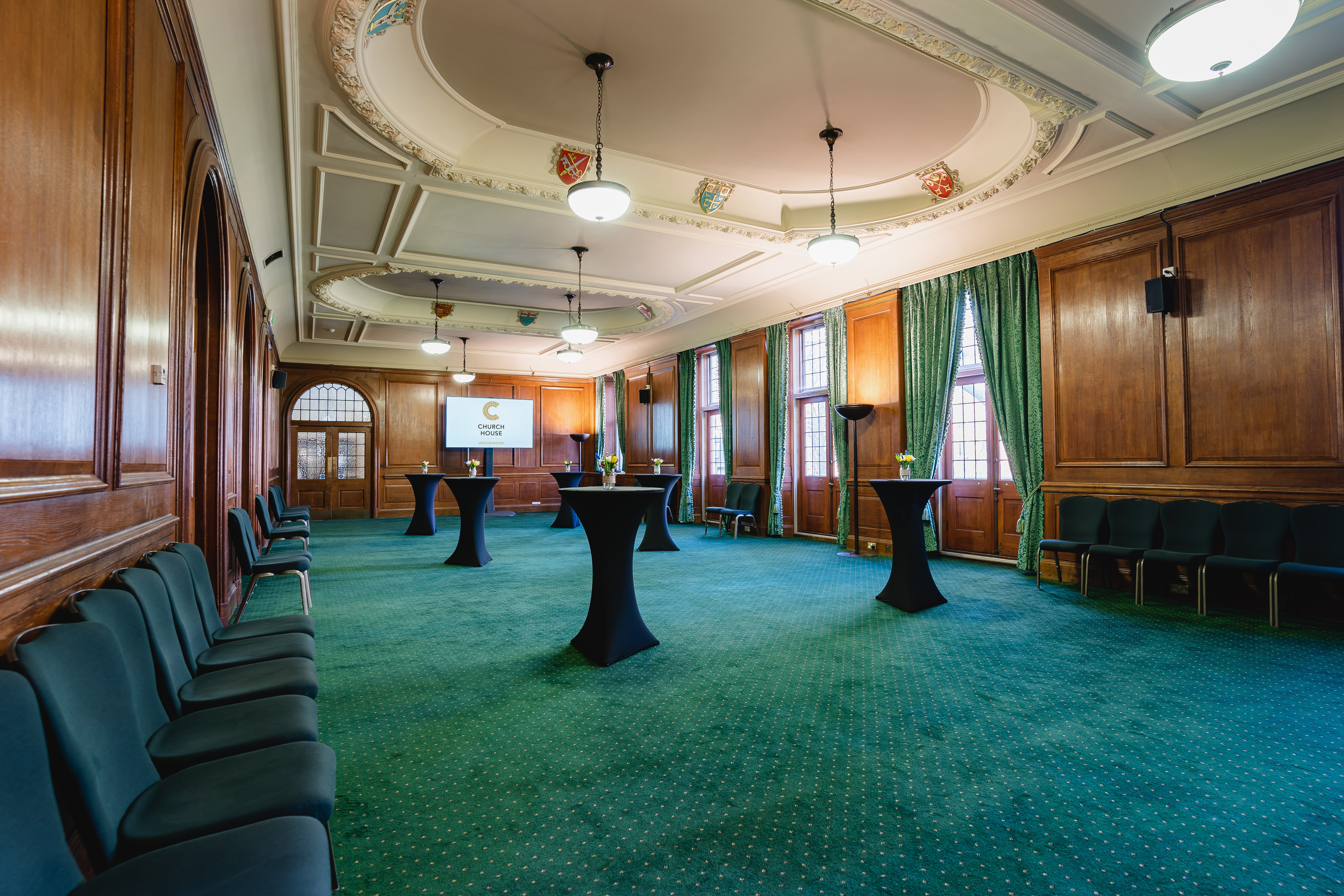 Spacious meeting room with wooden paneling for summer parties at Church House Westminster.