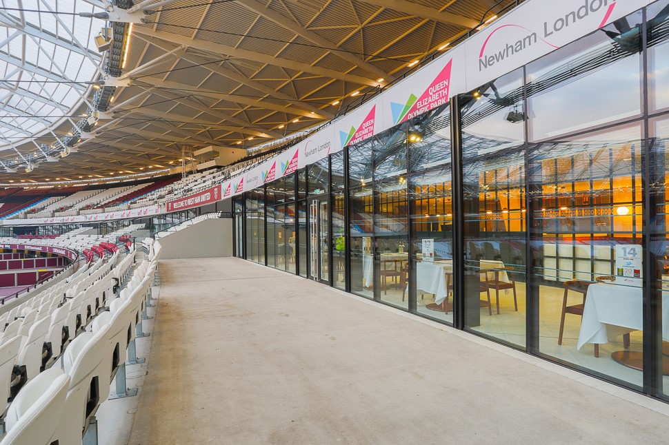 Modern event space in London Stadium with glass walls, ideal for corporate events.