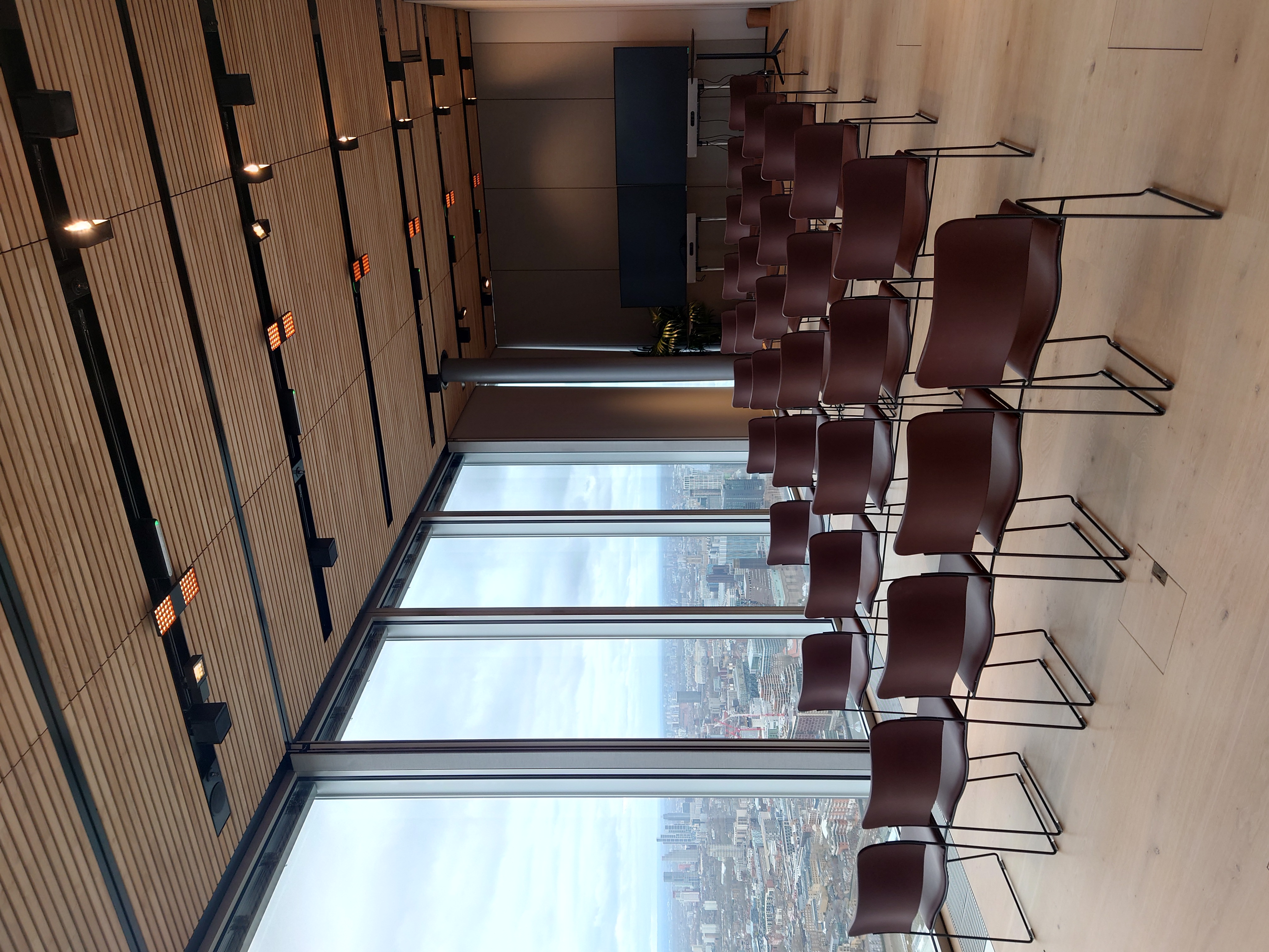 Modern event space at The Executive Suites, featuring city views and tech-friendly setup.