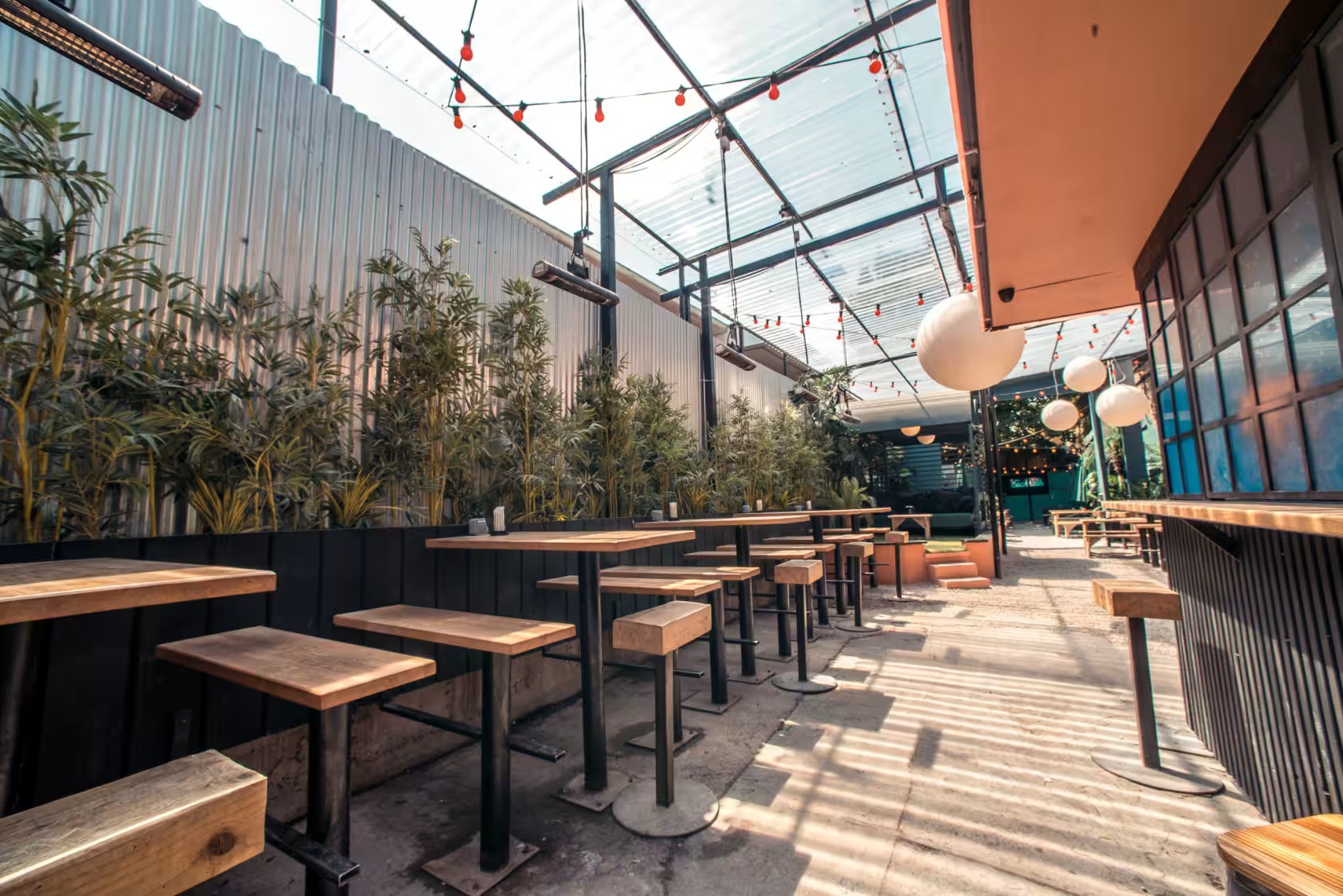 Versatile event space with greenery, ideal for gatherings and networking in The Garden.