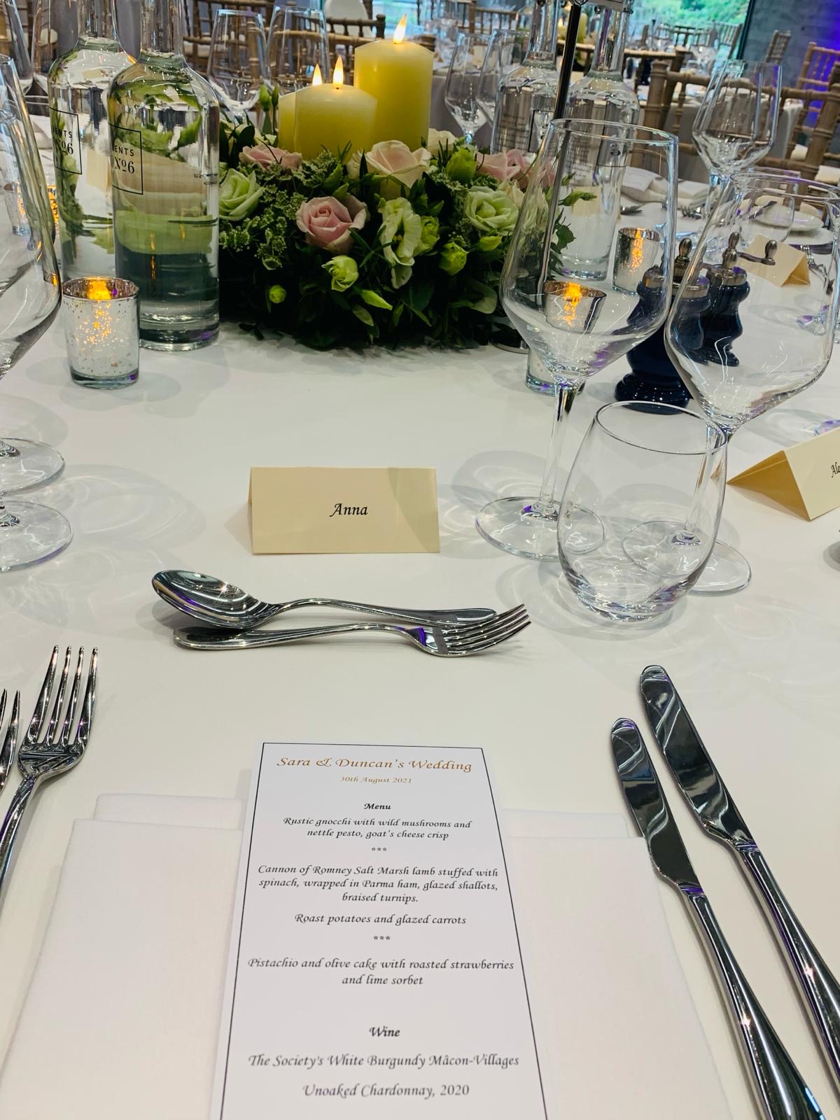 Elegant wedding dining table with personalized place settings and refined decor.