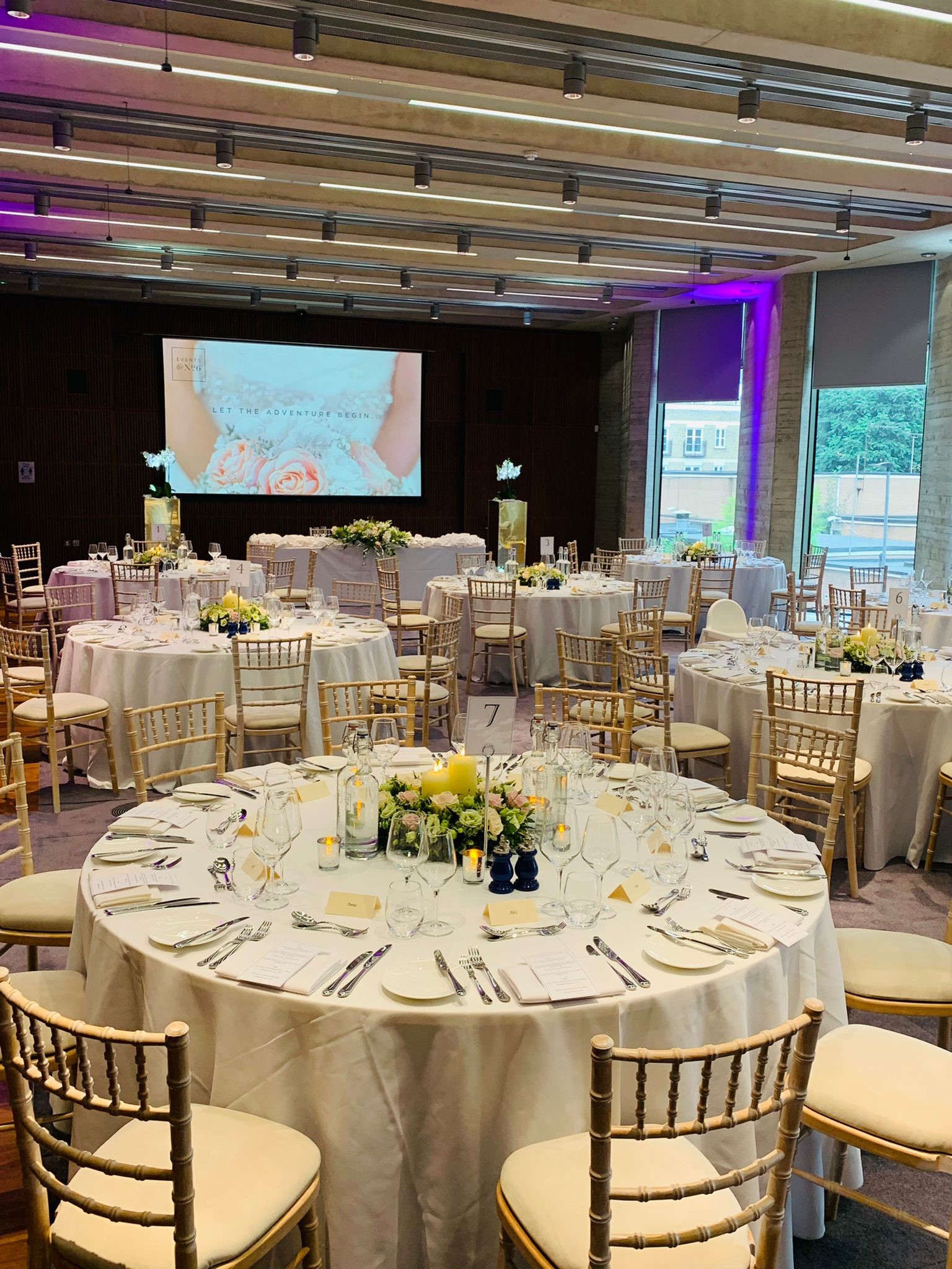 Elegant banquet hall with floral centerpieces for weddings and formal events.