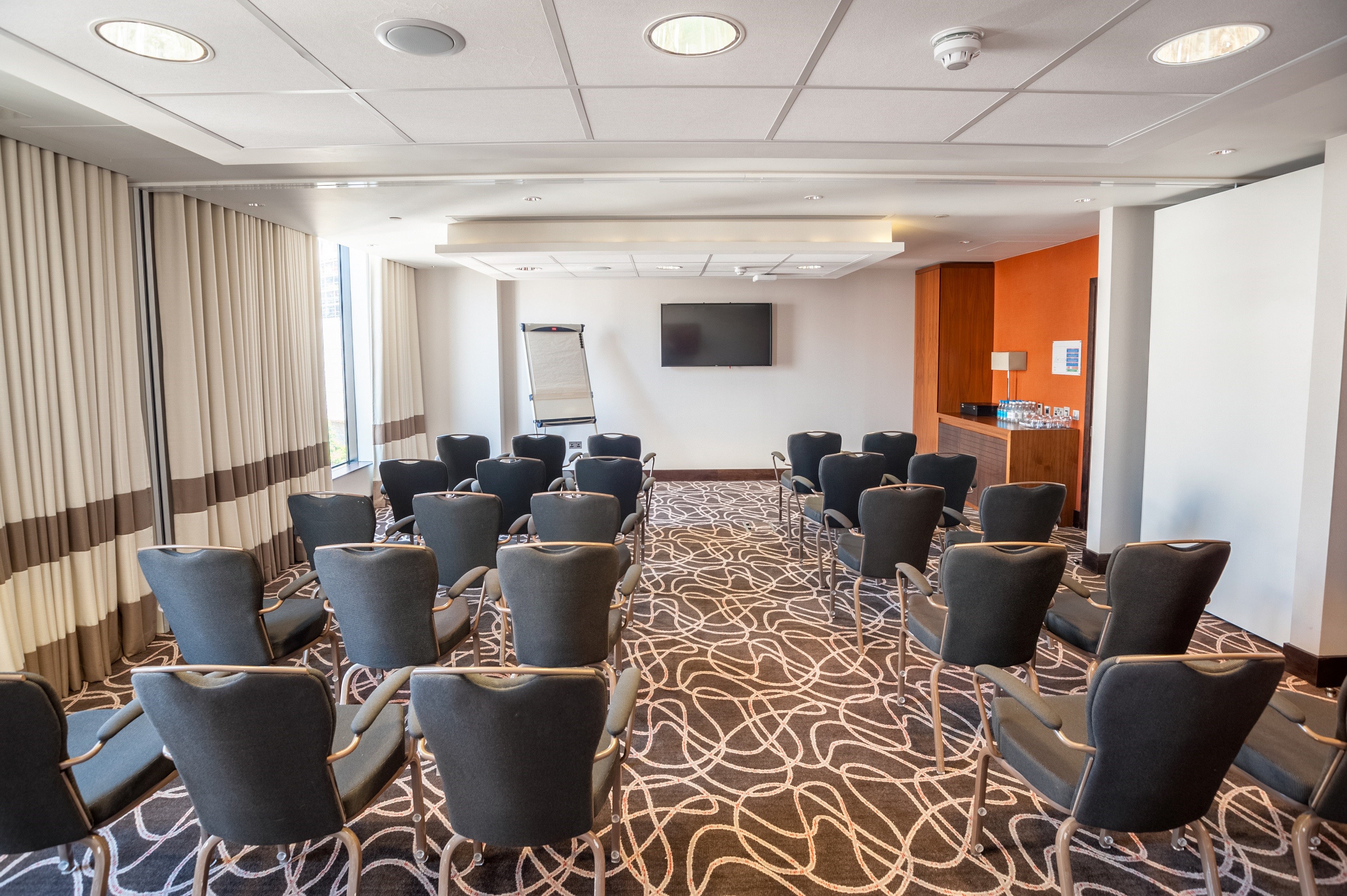 Hilton London Wembley meeting room with stylish chairs and natural light for workshops.