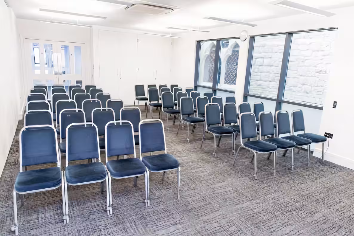 Ruby Suite in Rock Tower with blue chairs, perfect for meetings and workshops.